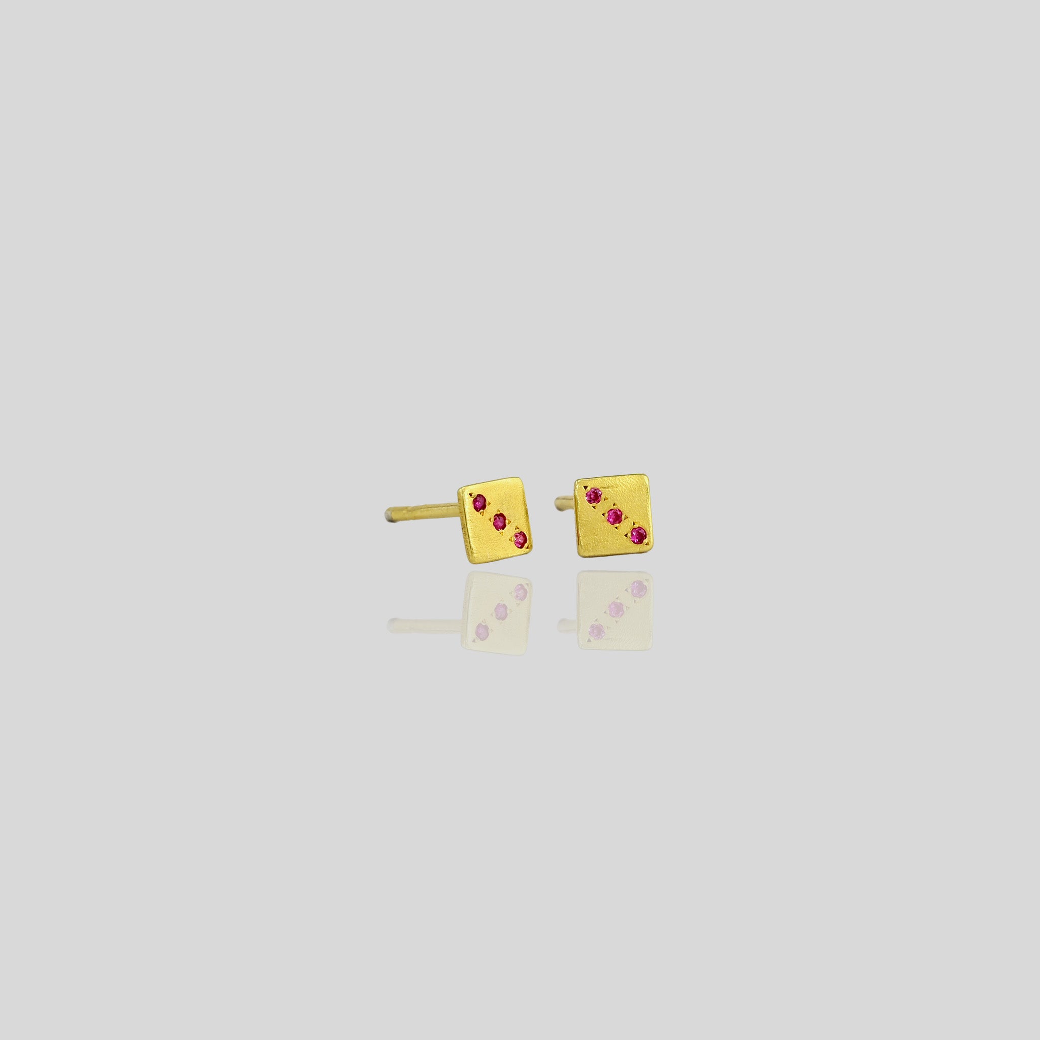 Lucky Charm Ruby Gold Stud Earrings with Playful Dice Pattern.