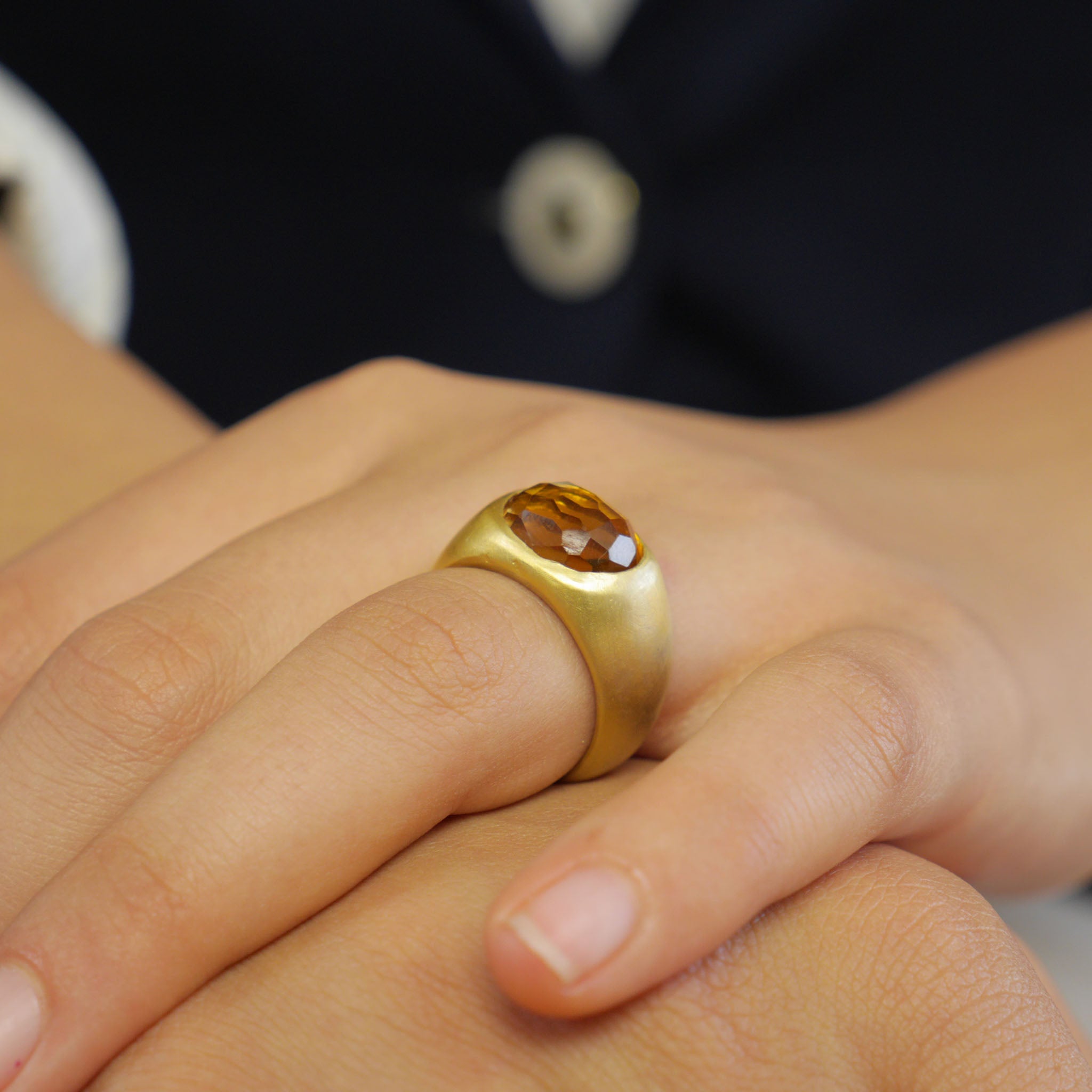 A timeless gold oval ring adorned with a captivating Citrine gemstone on a model. This classic piece exudes traditional elegance and is beloved for its enduring appeal.