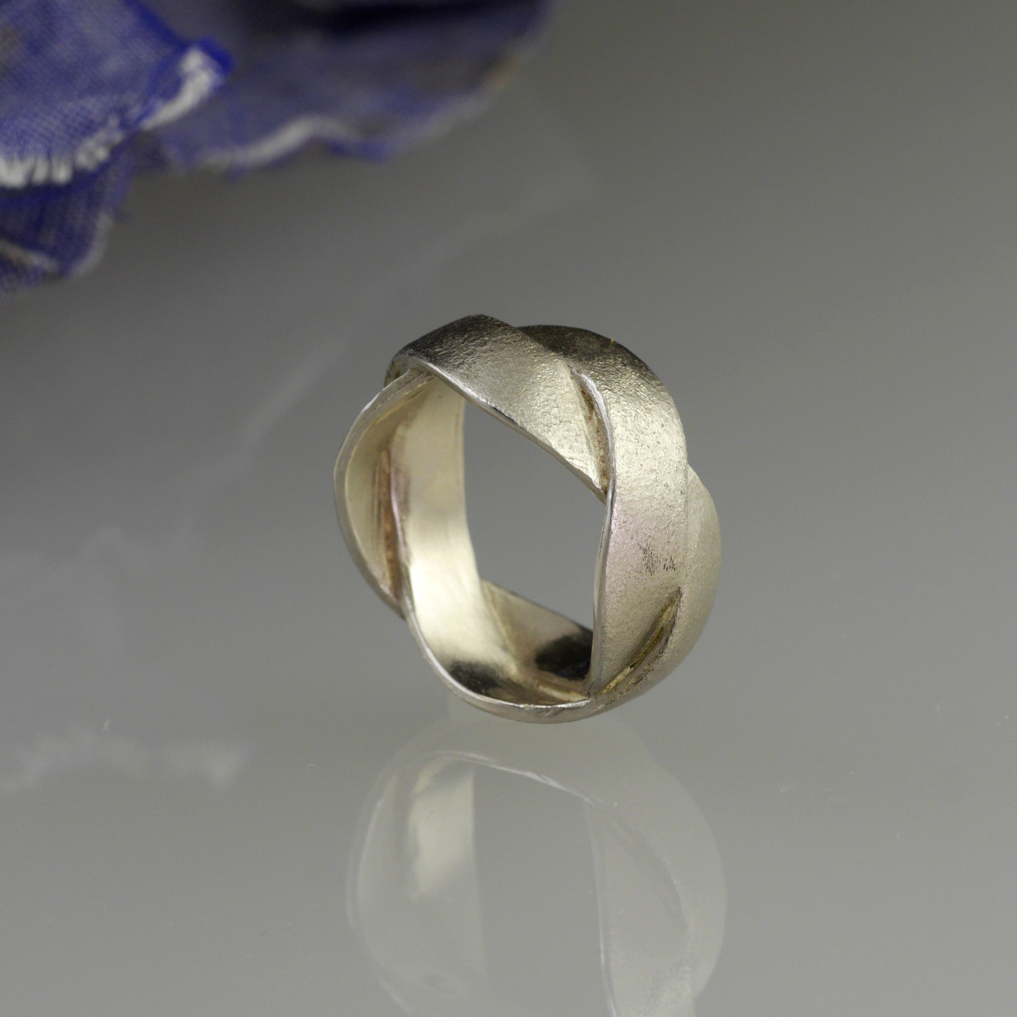 Handmade 18k White Gold ring with braided bands, offering an elegant and versatile addition to both everyday wear and special occasions. A timeless classic with a unique twist.