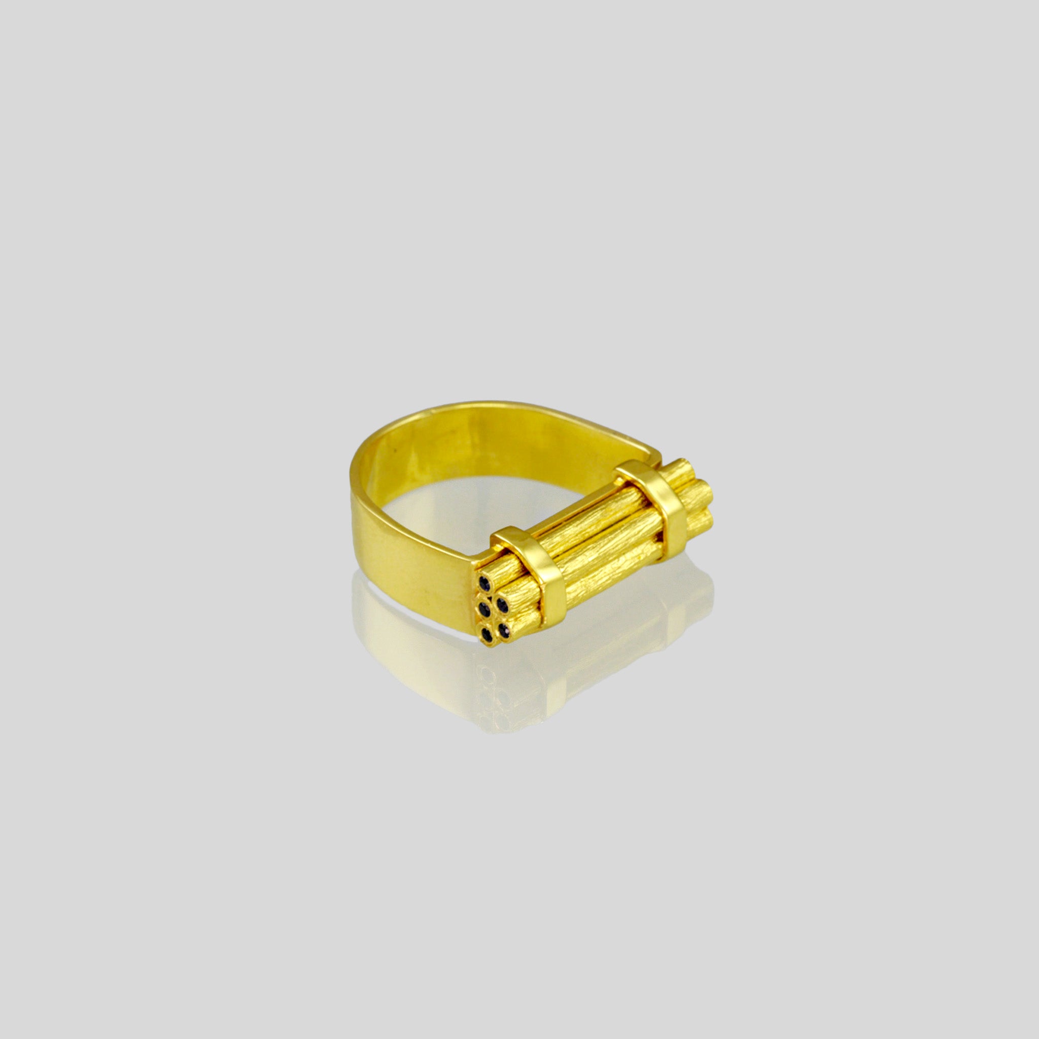 Handcrafted gold ring with stacked wood-inspired design, adorned with sparkling Sapphires for added color and radiance. Contemporary and comfortable statement piece.