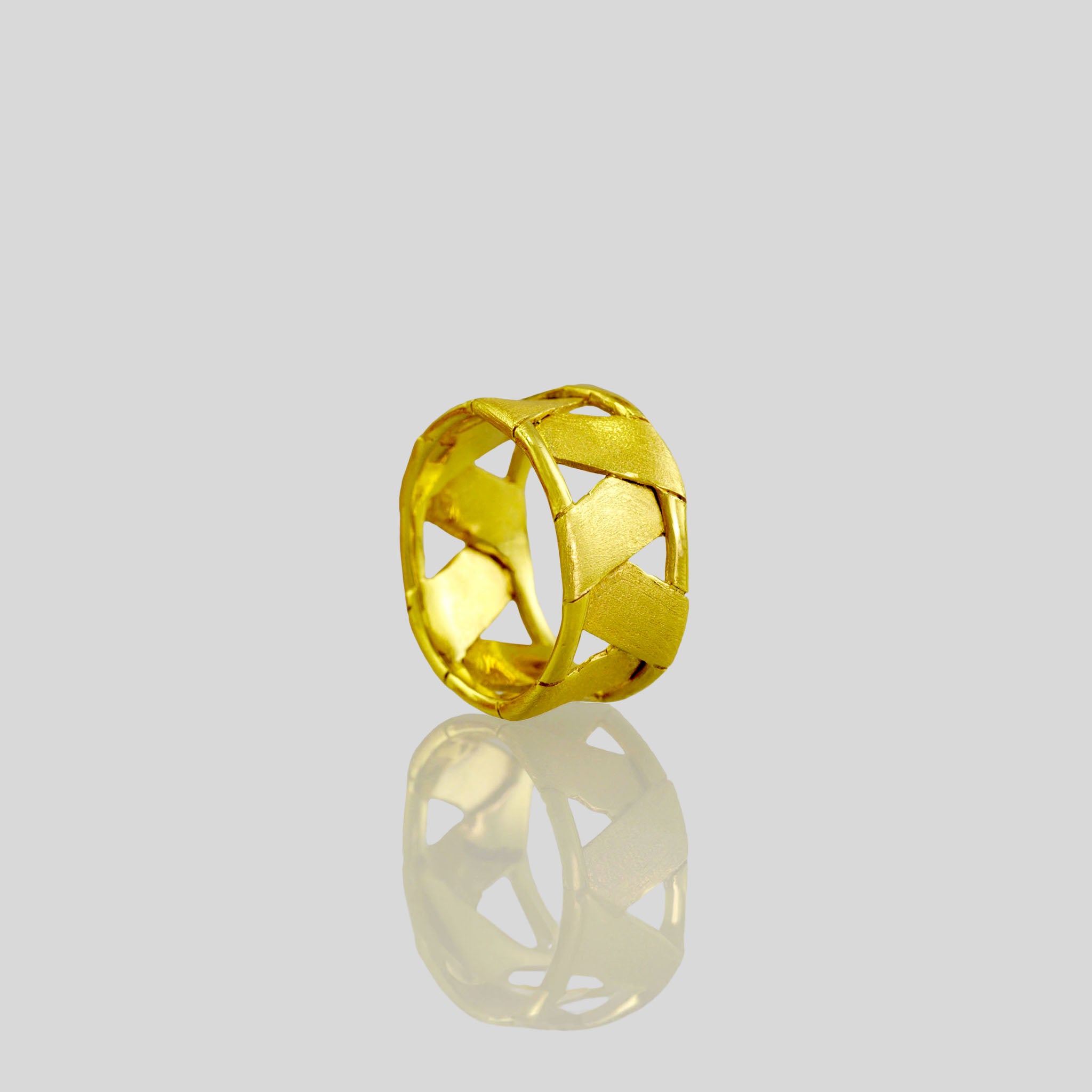 Unique Yellow Gold Braided Ring fashioned in the shape of a drum, offering both boldness and comfort with its lightweight design.