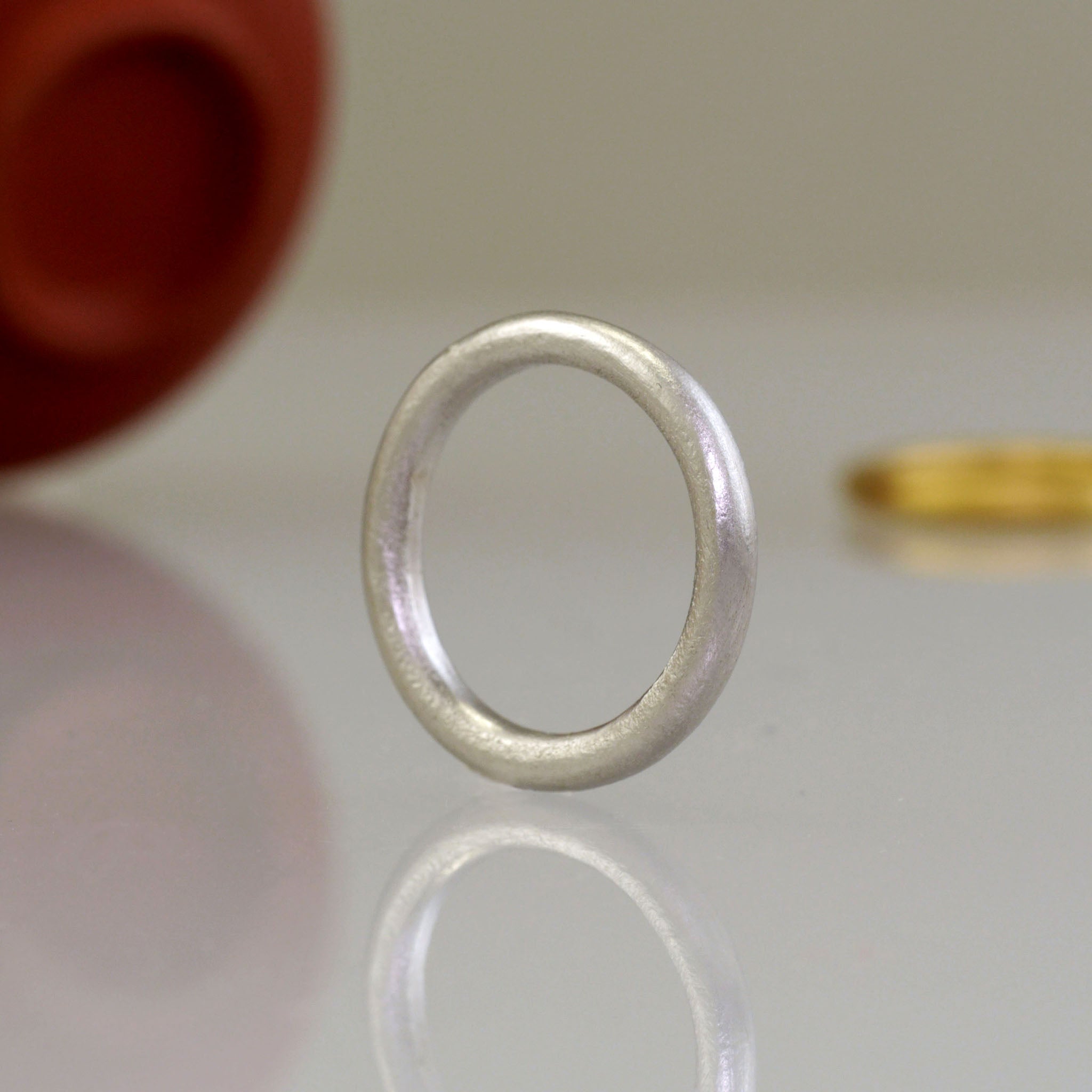 Close up of Round profile White Gold wedding ring with minimalist design, perfect for your special occasion.
