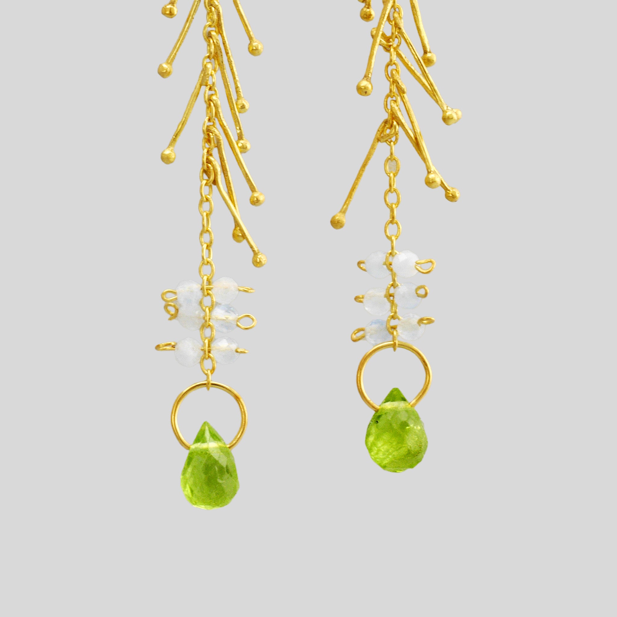 Detail of 18k Yellow Gold Venus Stud Earrings with Aquamarine and Peridot accents, inspired by the goddess emerging from the sea. Light and fluid, adding celestial charm to any look.