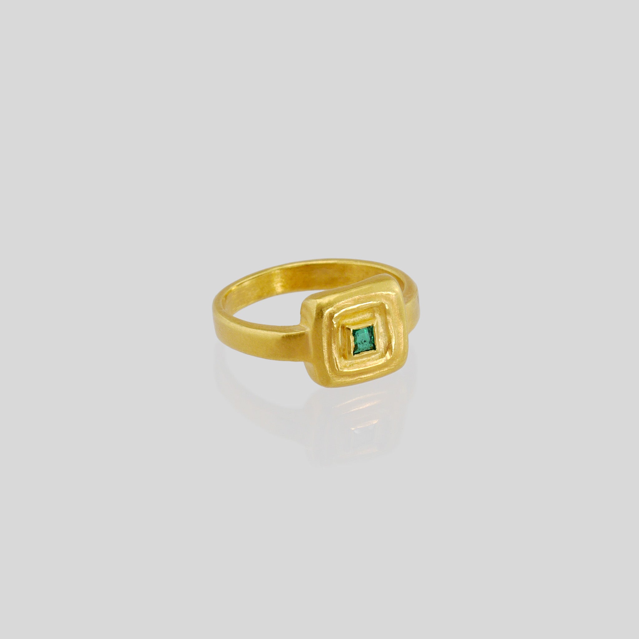Handcrafted 18k Gold ring featuring a square Emerald set atop a square surface, evoking the ancient Egyptian era's golden jewelry of the Pharaohs.