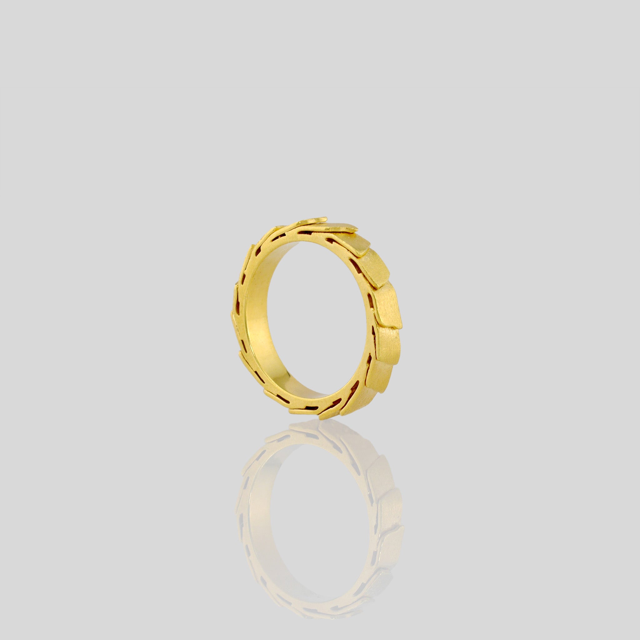 A captivating gold ring adorned with overlapping layers, evoking a sense of continuous motion and embrace. The inner surface is smooth, for optimal comfort.