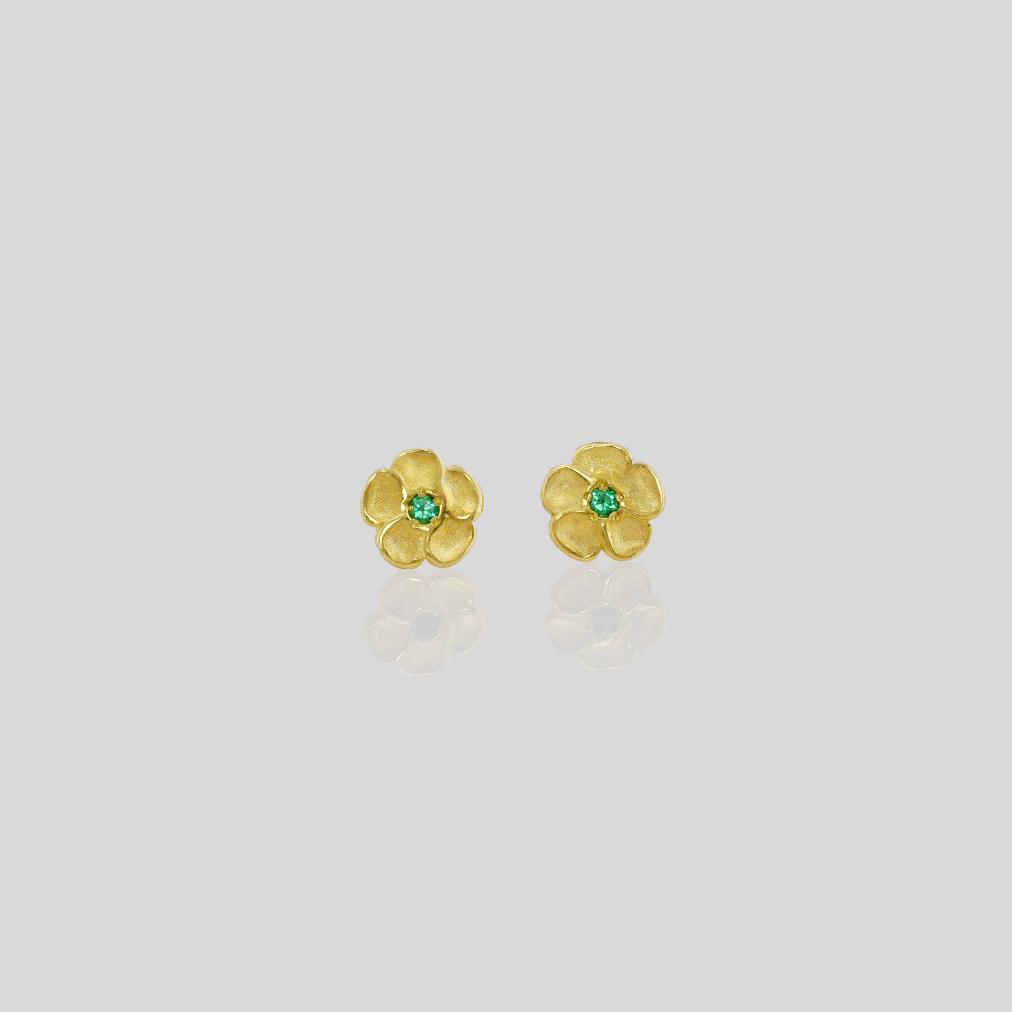 Delicate yellow gold flower stud earrings with a sparkling Emerald center. Perfect for any occasion!