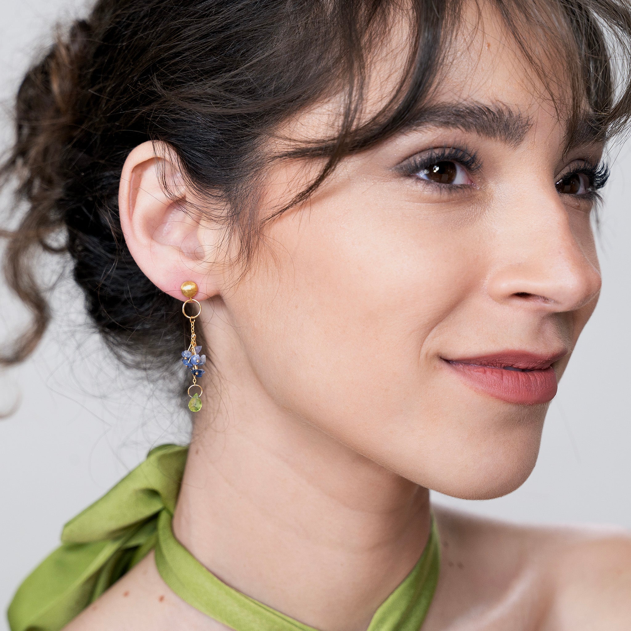 Timeless elegance meets luxury in these Yellow Gold earrings adorned with raw blue sapphires and a dangling Peridot drop.