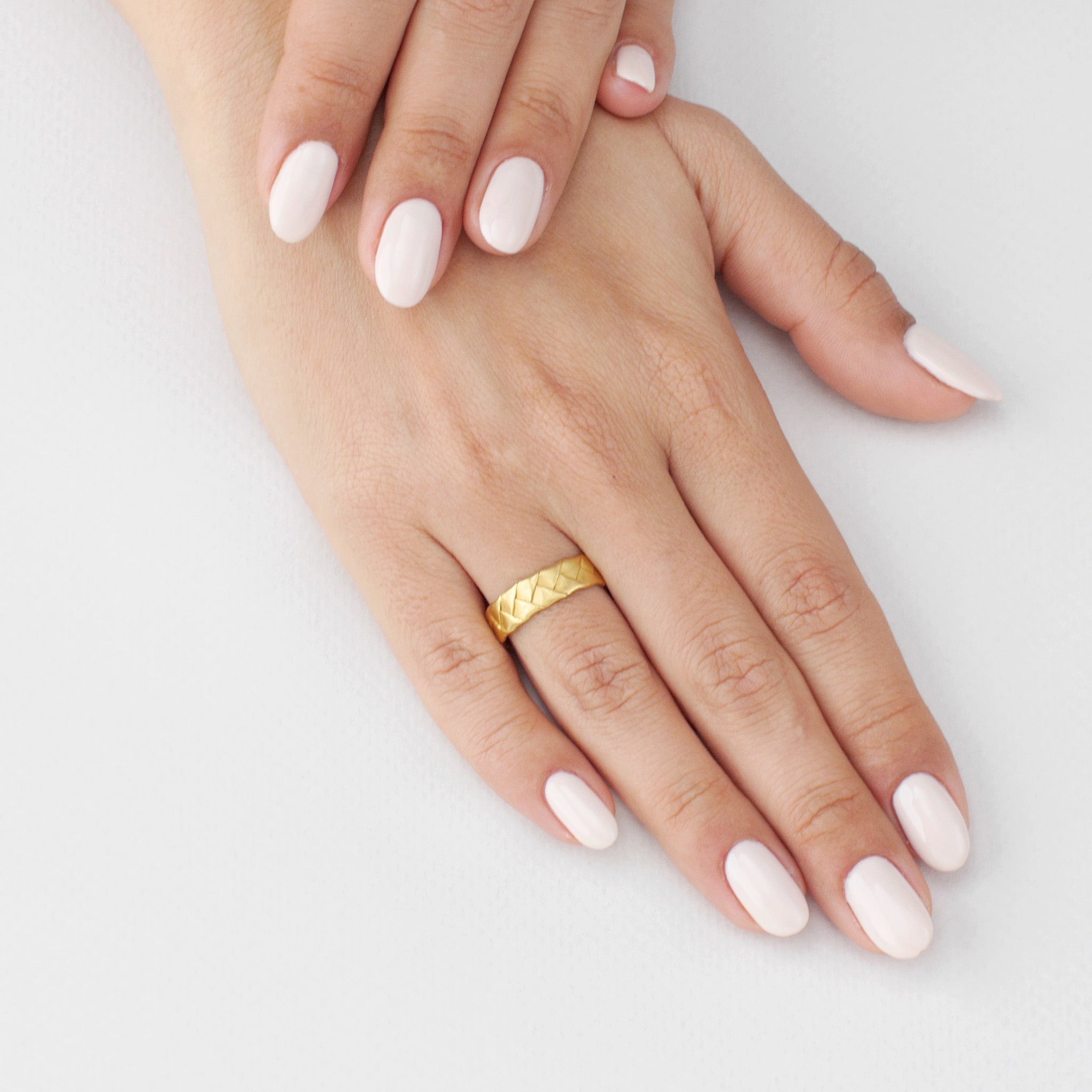 Model showcasing the Classic Yellow Gold Braid Ring, highlighting its intricate braiding and everyday elegance.