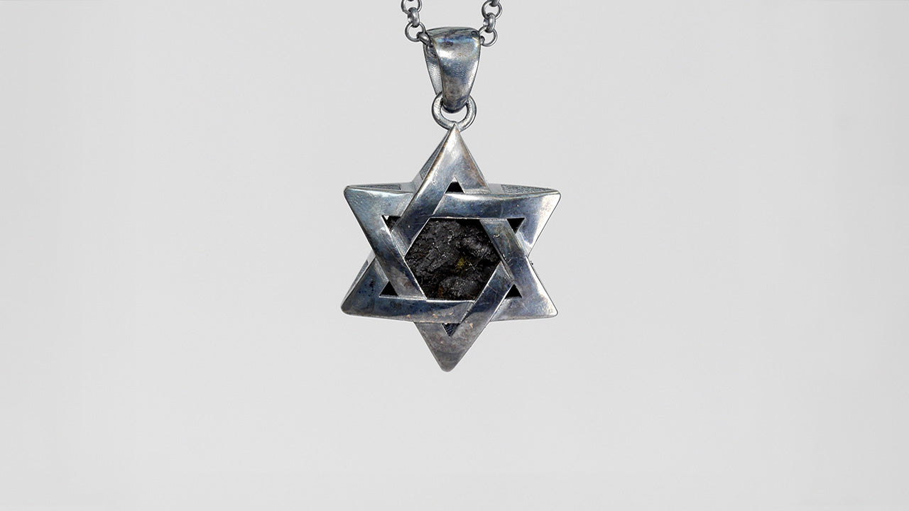 925 Silver Star of David pendant containing shrapnel shard from Idan's injury, symbolic of family's perseverance and bravery.