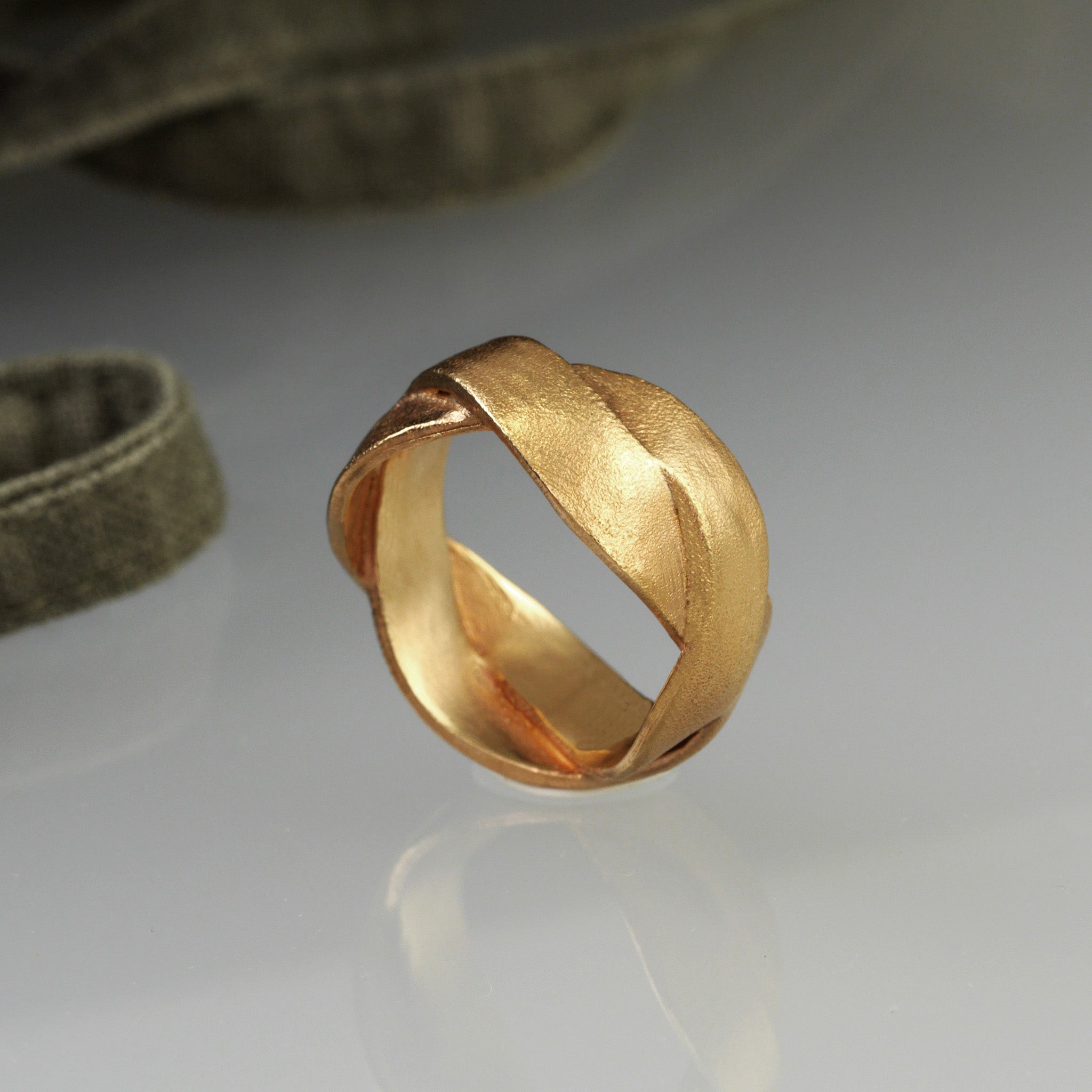 Handmade 18k Rose Gold ring with braided bands, offering an elegant and versatile addition to both everyday wear and special occasions. A timeless classic with a unique twist.