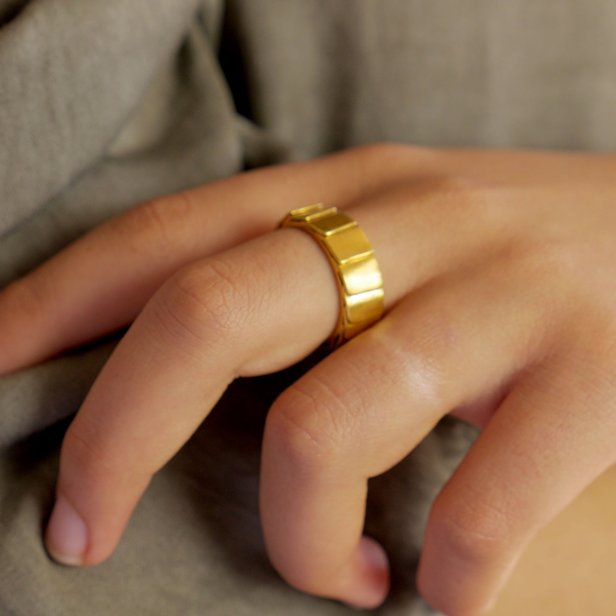 18k Gold ring on a model with overlapping layers, evoking a sense of perpetual motion and embrace. Smooth inner surface ensures maximum comfort.