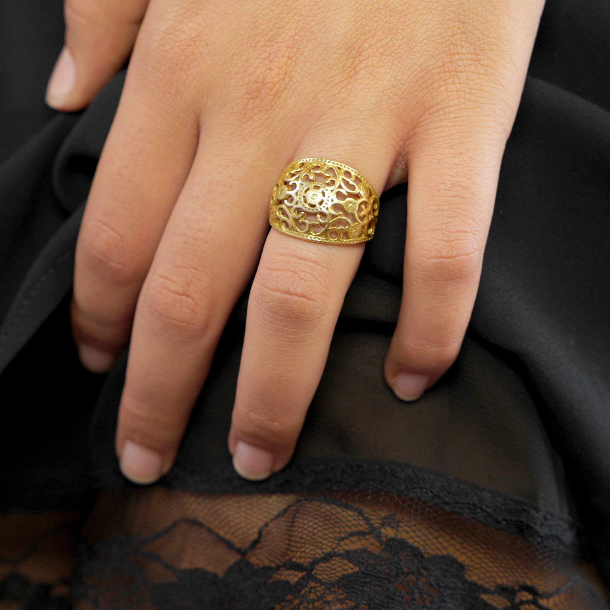 Ornamental 18k Gold Ring on a model's hand, featuring intricate embroidery artistry for a regal elegance. Expert craftsmanship and lightweight design ensure exquisite comfort.