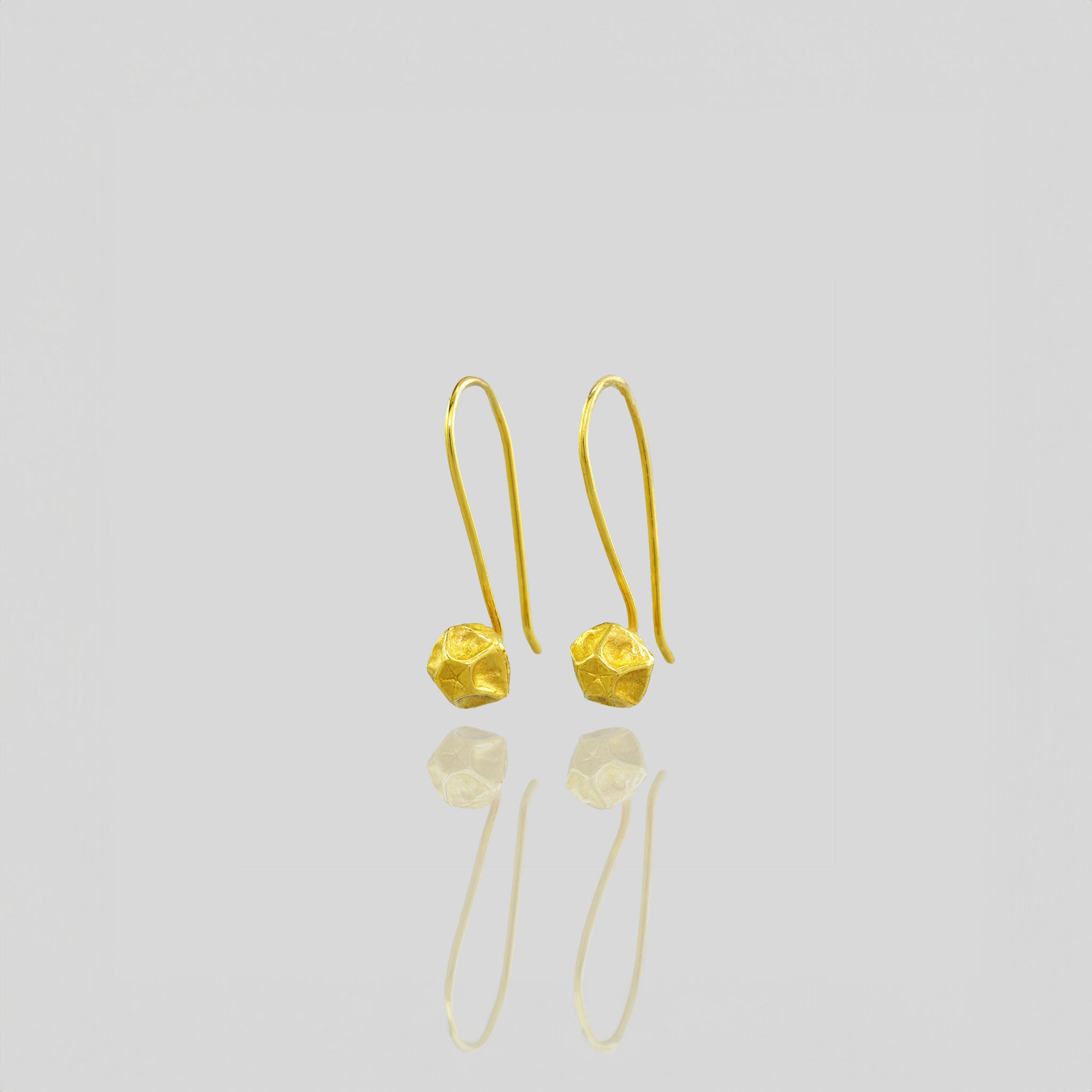 Handcrafted Gold Pentagon Earrings with Intricate Lines.