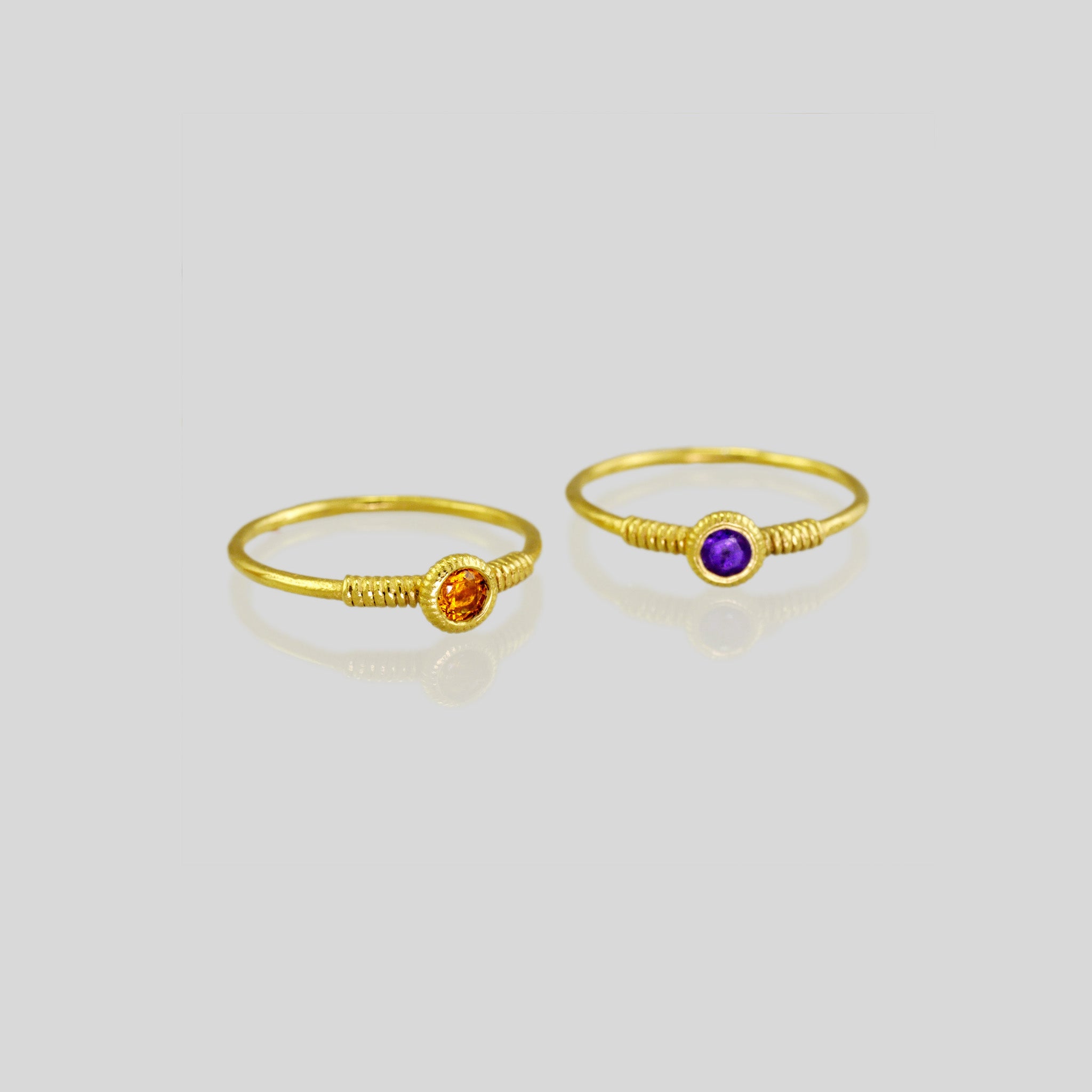 Delicate gold ring with coiled design and adorned with either Citrine or Amethyst gemstone. Poetically shaped and radiating elegance.