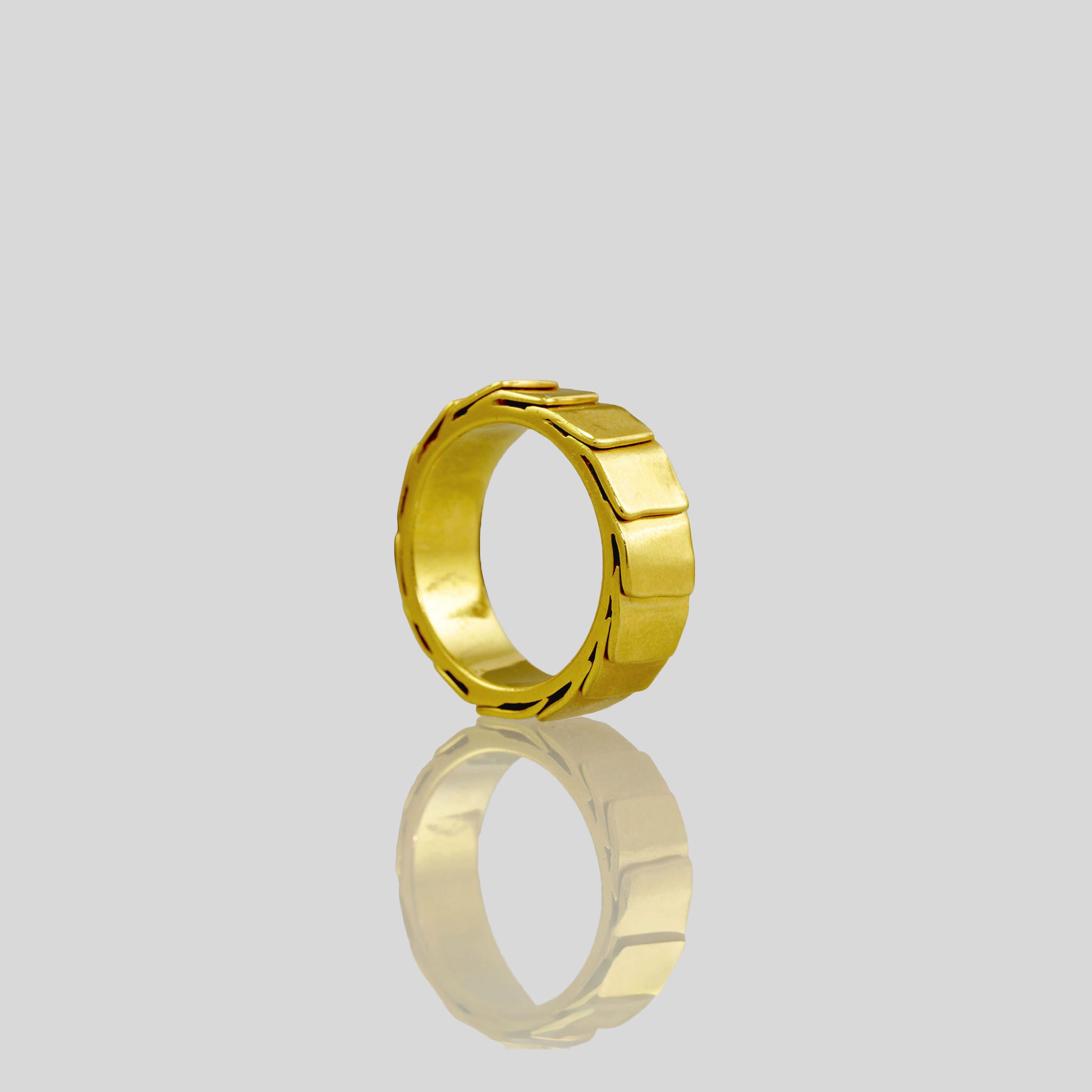 18k Gold ring with overlapping layers, evoking a sense of perpetual motion and embrace. Smooth inner surface ensures maximum comfort.