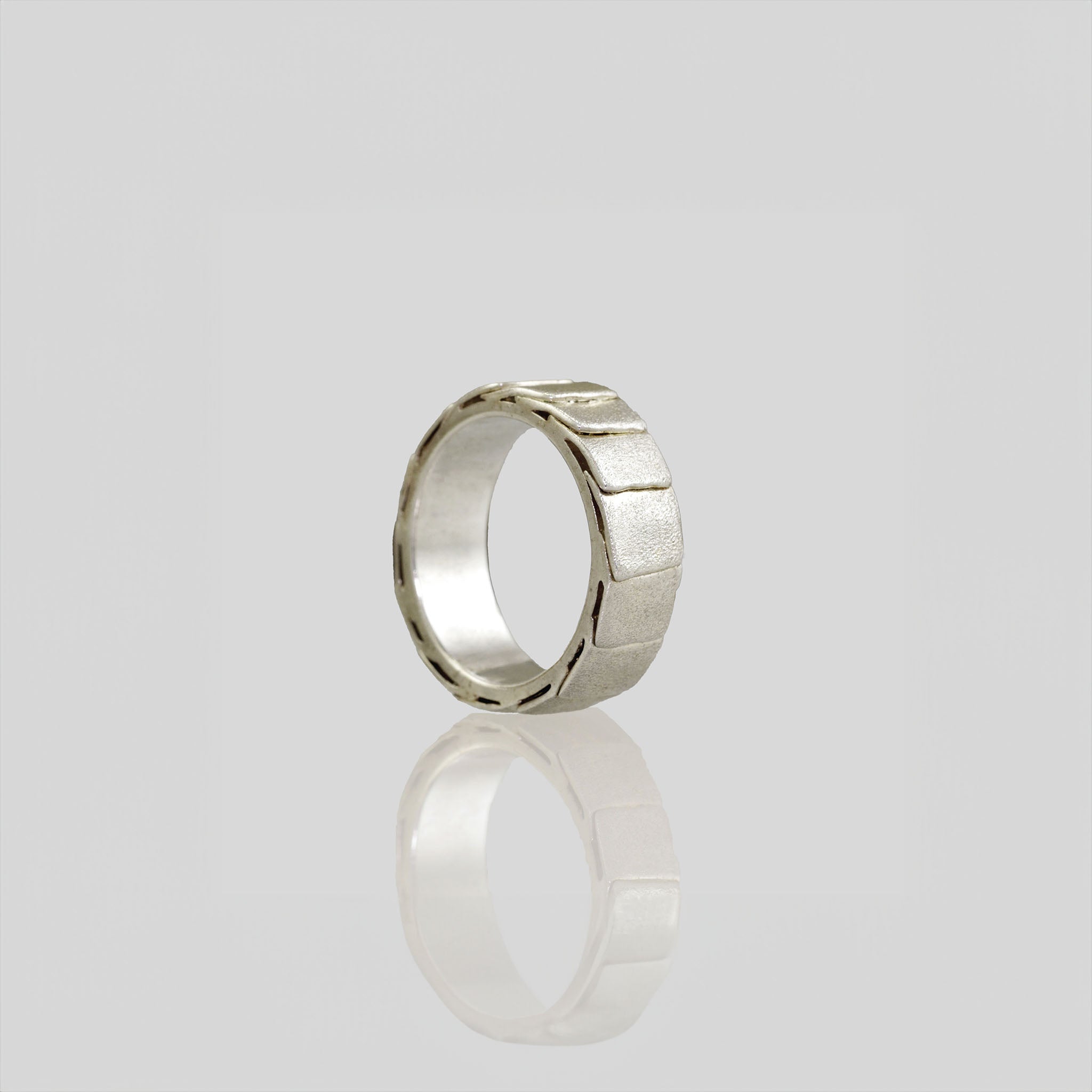 18k White Gold ring with overlapping layers, evoking a sense of perpetual motion and embrace. Smooth inner surface ensures maximum comfort.