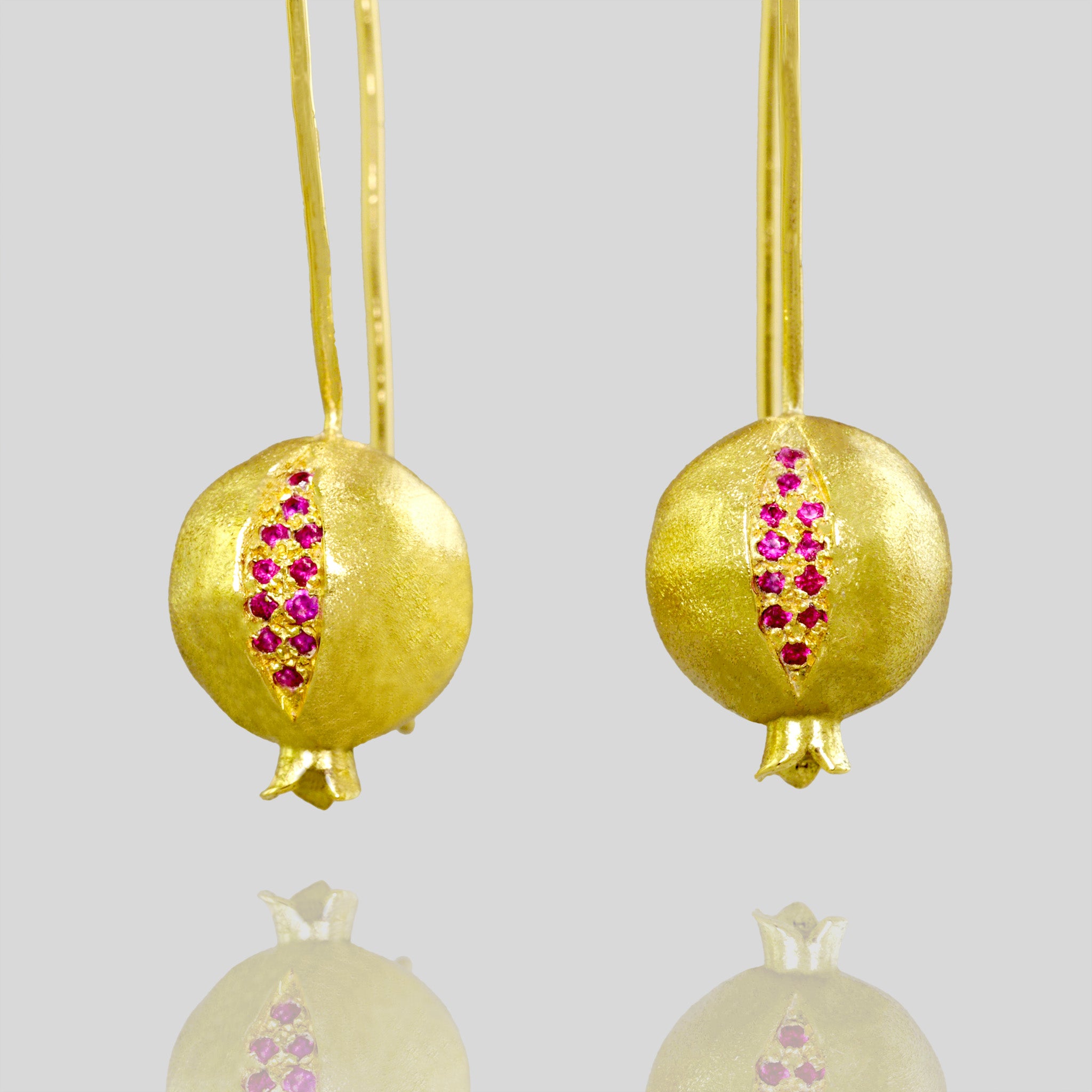 close up of 18k Gold Pomegranate Drop Earrings with Sparkling Rubies