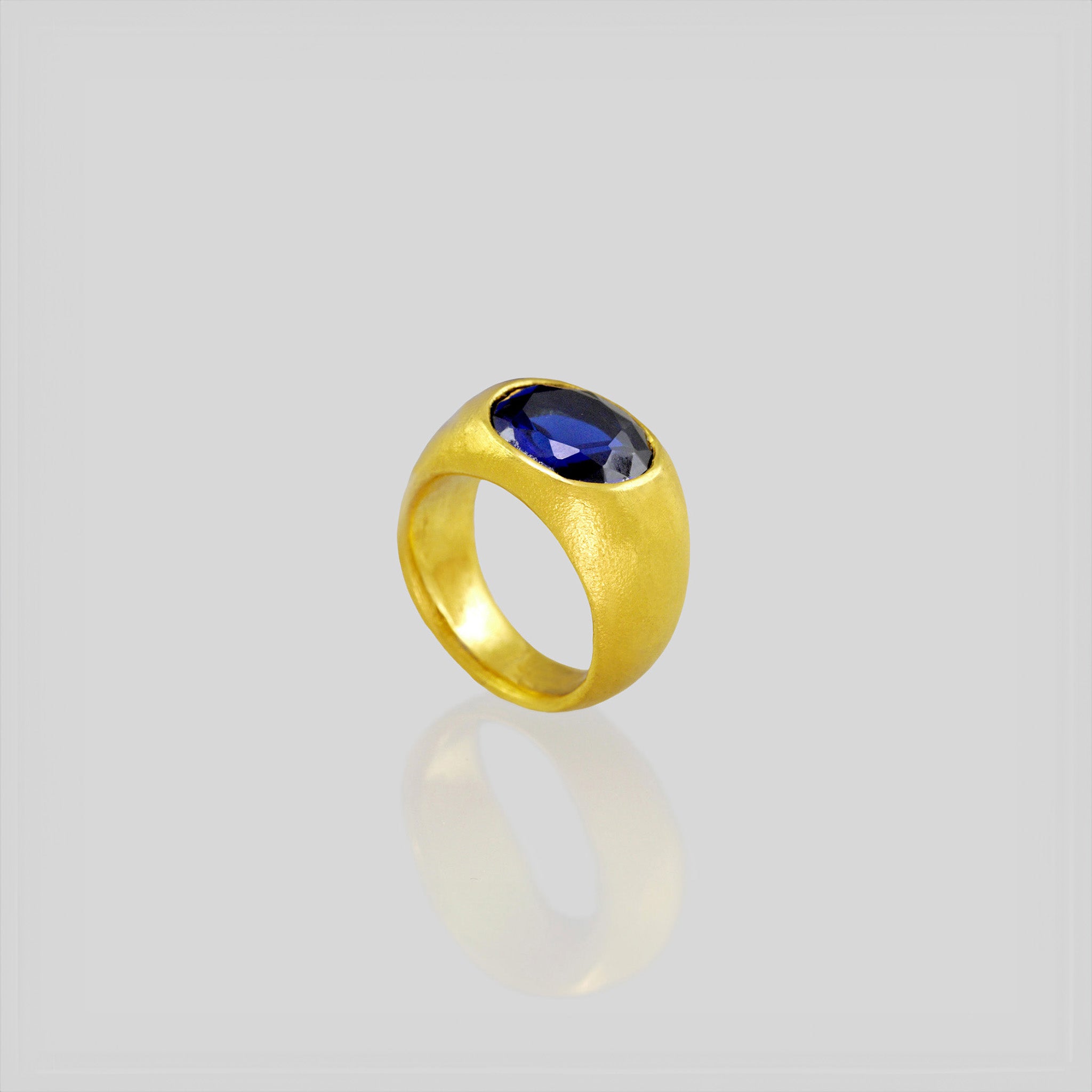 A timeless gold oval ring adorned with a captivating Sapphire gemstone. This classic piece exudes traditional elegance and is beloved for its enduring appeal.
