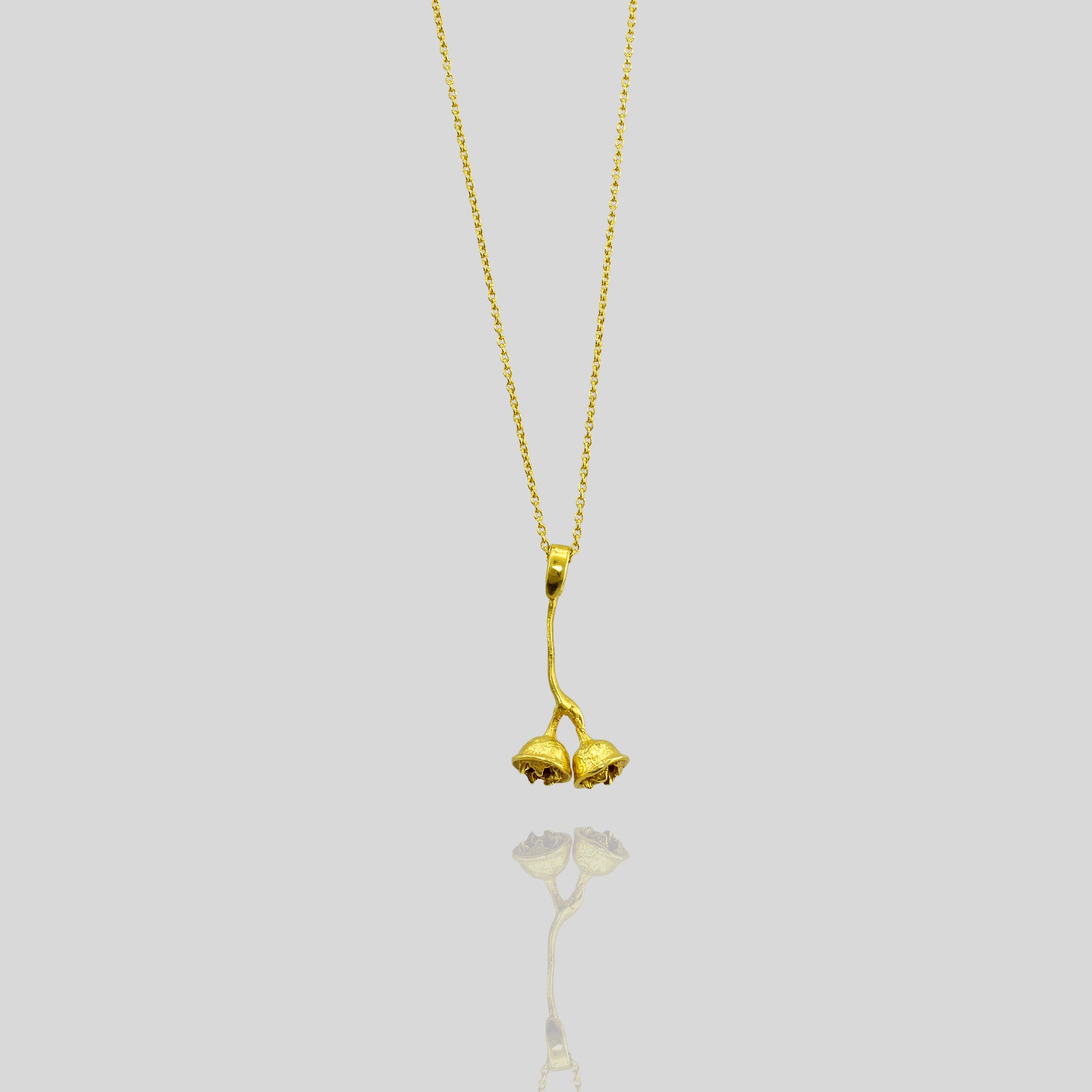 18k Gold necklace modeled after a eucalyptus branch, featuring two detailed dried seed pods, offering a realistic and natural look, ideal for everyday wear.