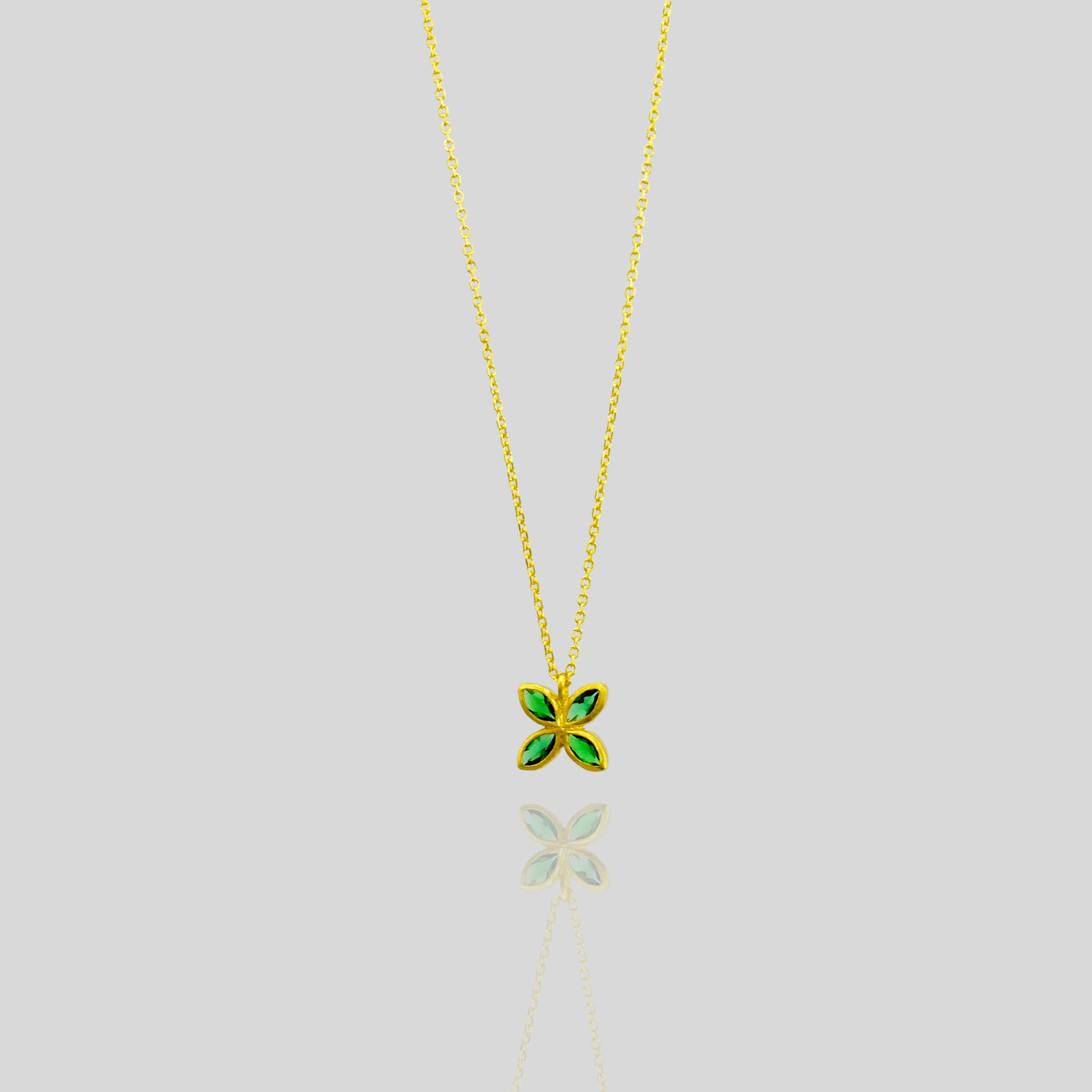 Elegant gold pendant with four marquise-cut Emeralds arranged into a delicate flower design, offering luxury and beauty suitable for any gift occasion.