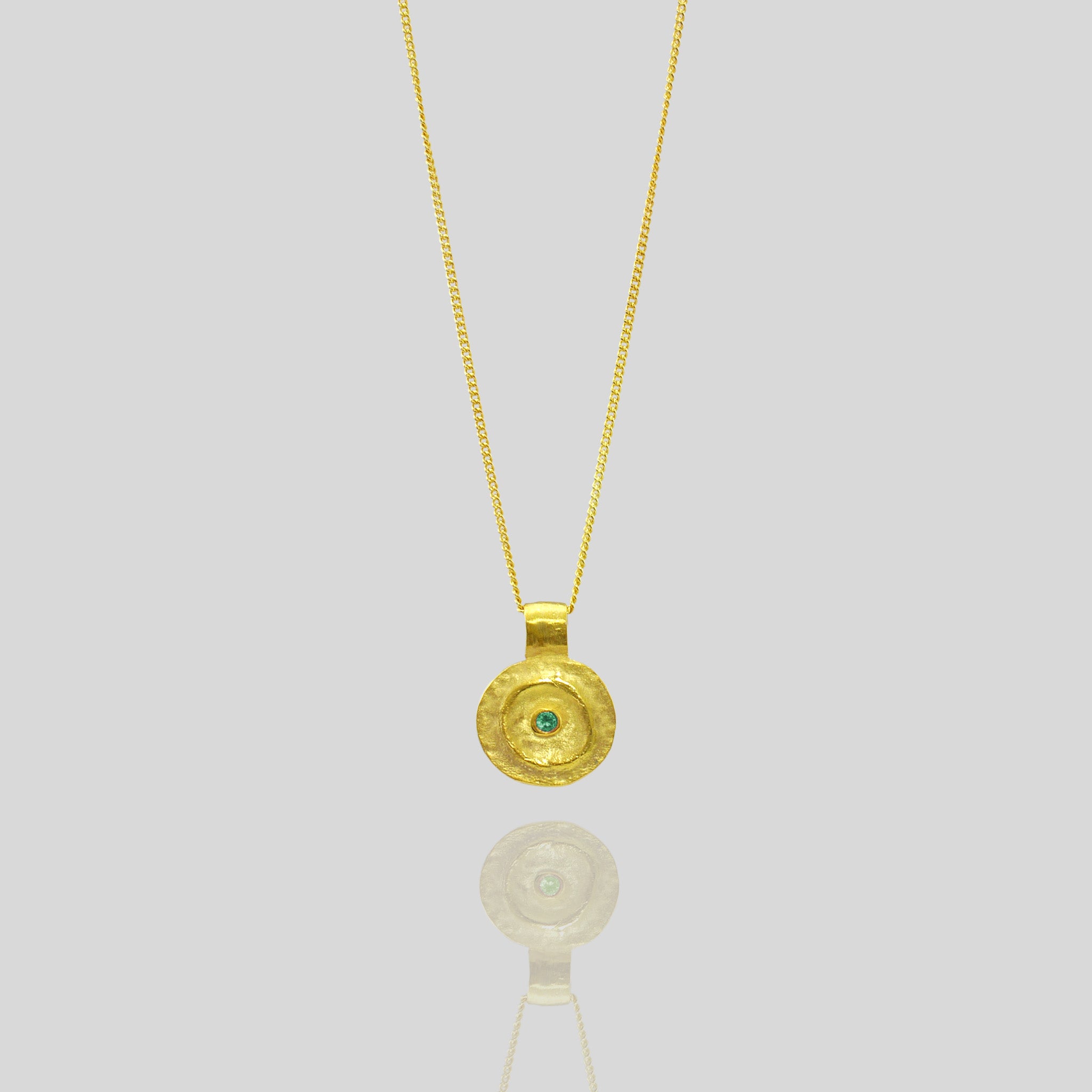 Pharaohs I - Ancient round gold pendant with a vivid Emerald gemstone at its center, reminiscent of the opulent jewelry of the Egyptian Pharaohs' era, crafted from yellow gold.