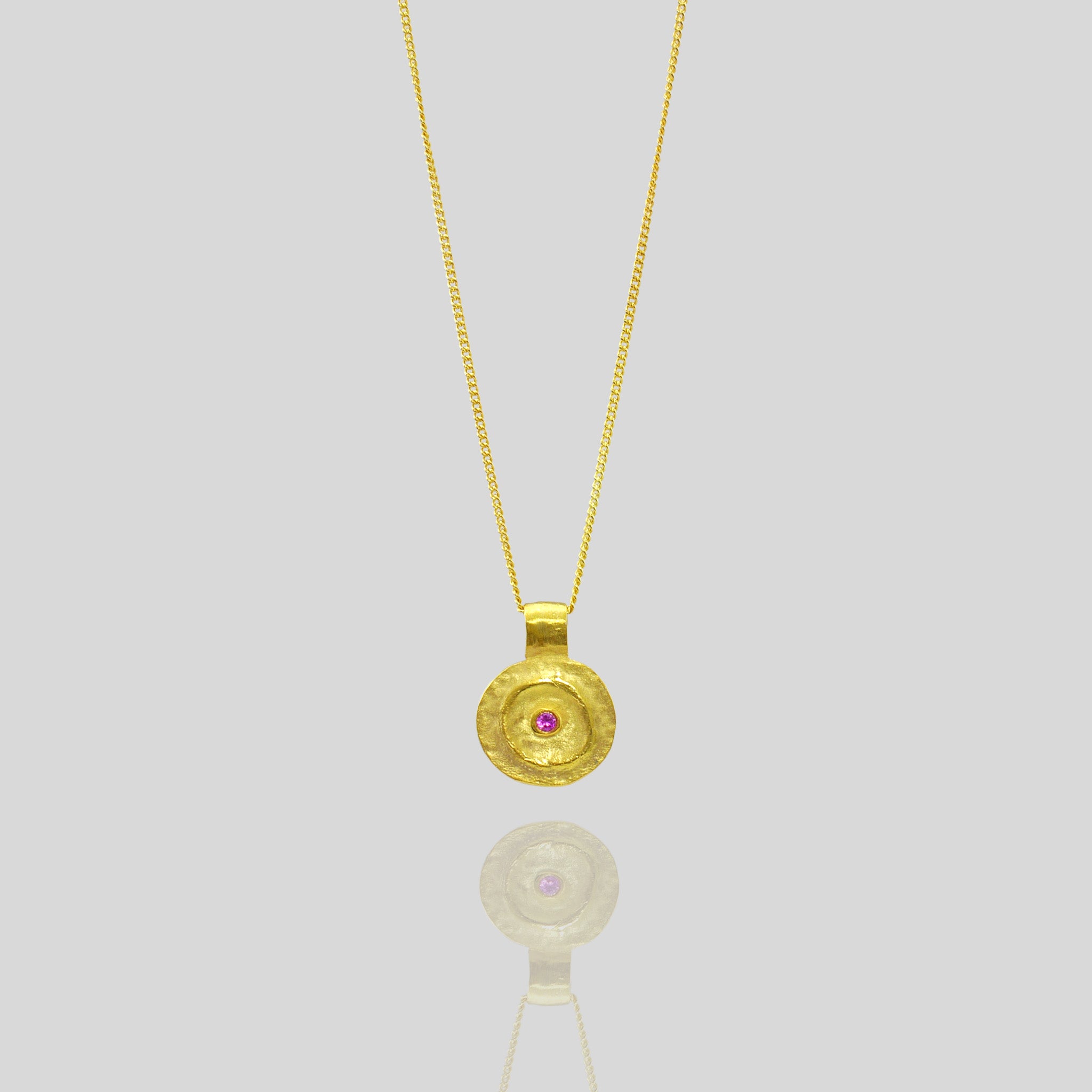 Pharaohs I - Ancient round gold pendant with a vivid Ruby gemstone at its center, reminiscent of the opulent jewelry of the Egyptian Pharaohs' era, crafted from yellow gold.