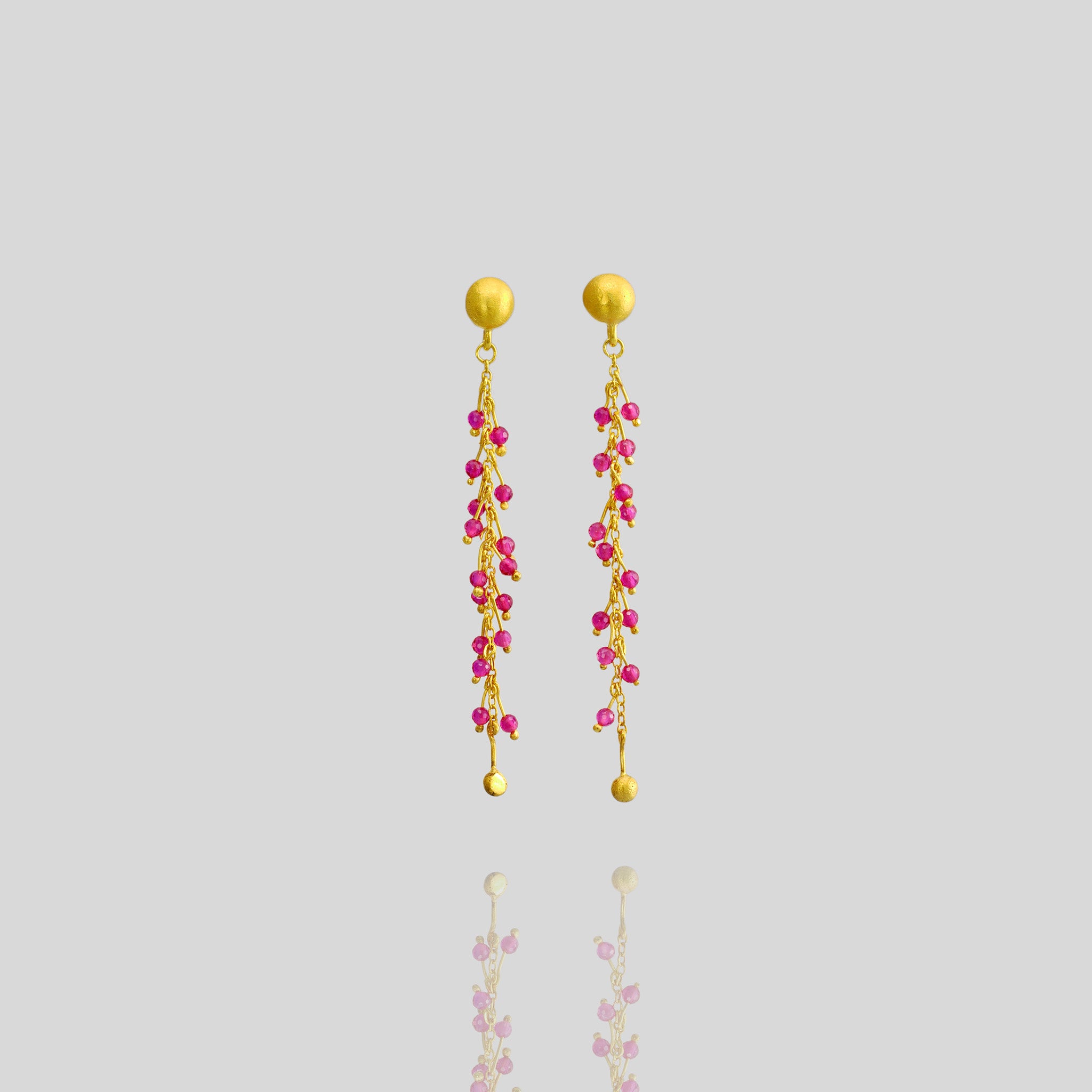 18k gold studs adorned with radiant ruby beads on shimmering gold threads, inspired by Venus emerging from the sea.