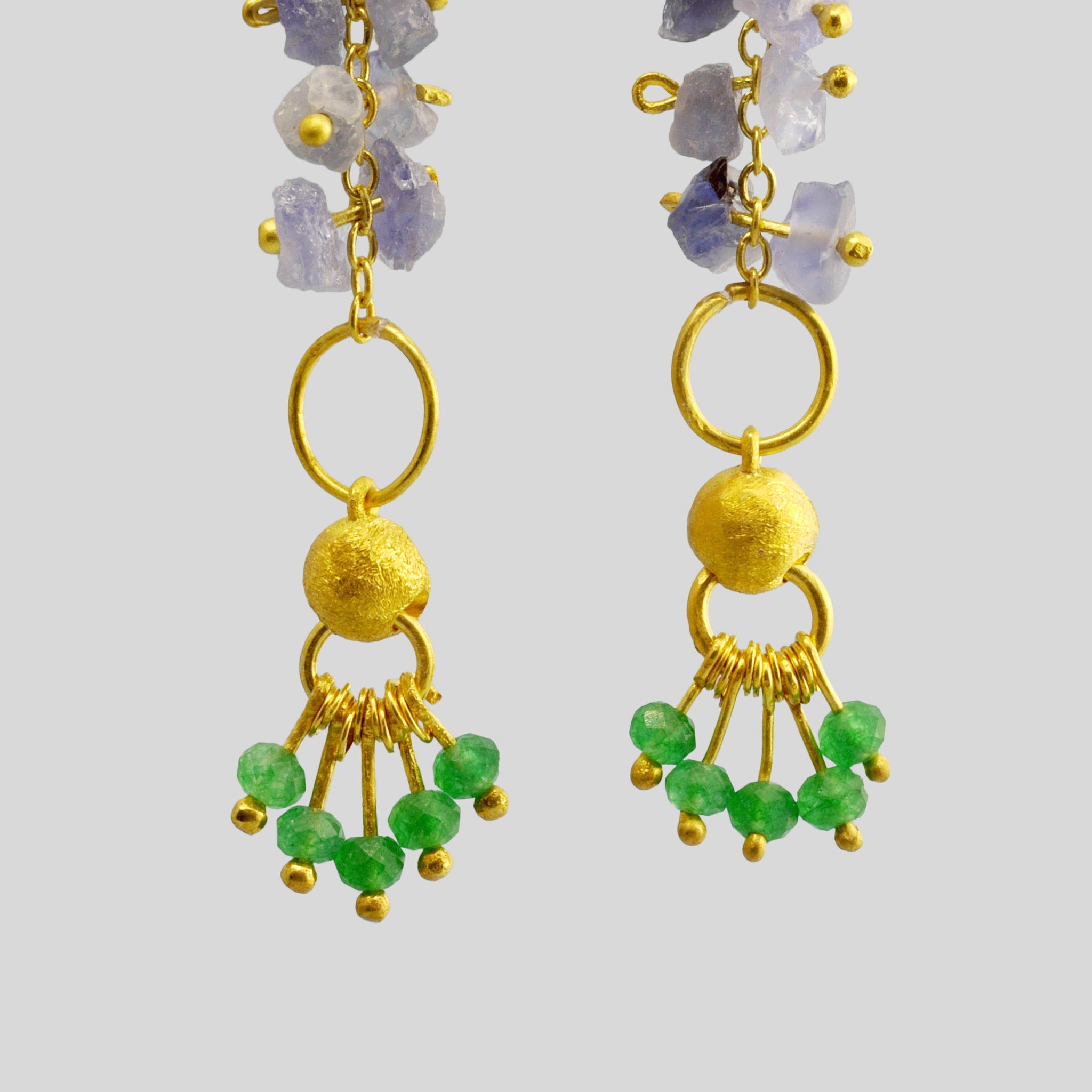 detail of Hand-crafted 18k Yellow Gold Venus Earrings with raw Sapphire and Emerald accents, exuding organic beauty and luxury for any occasion.