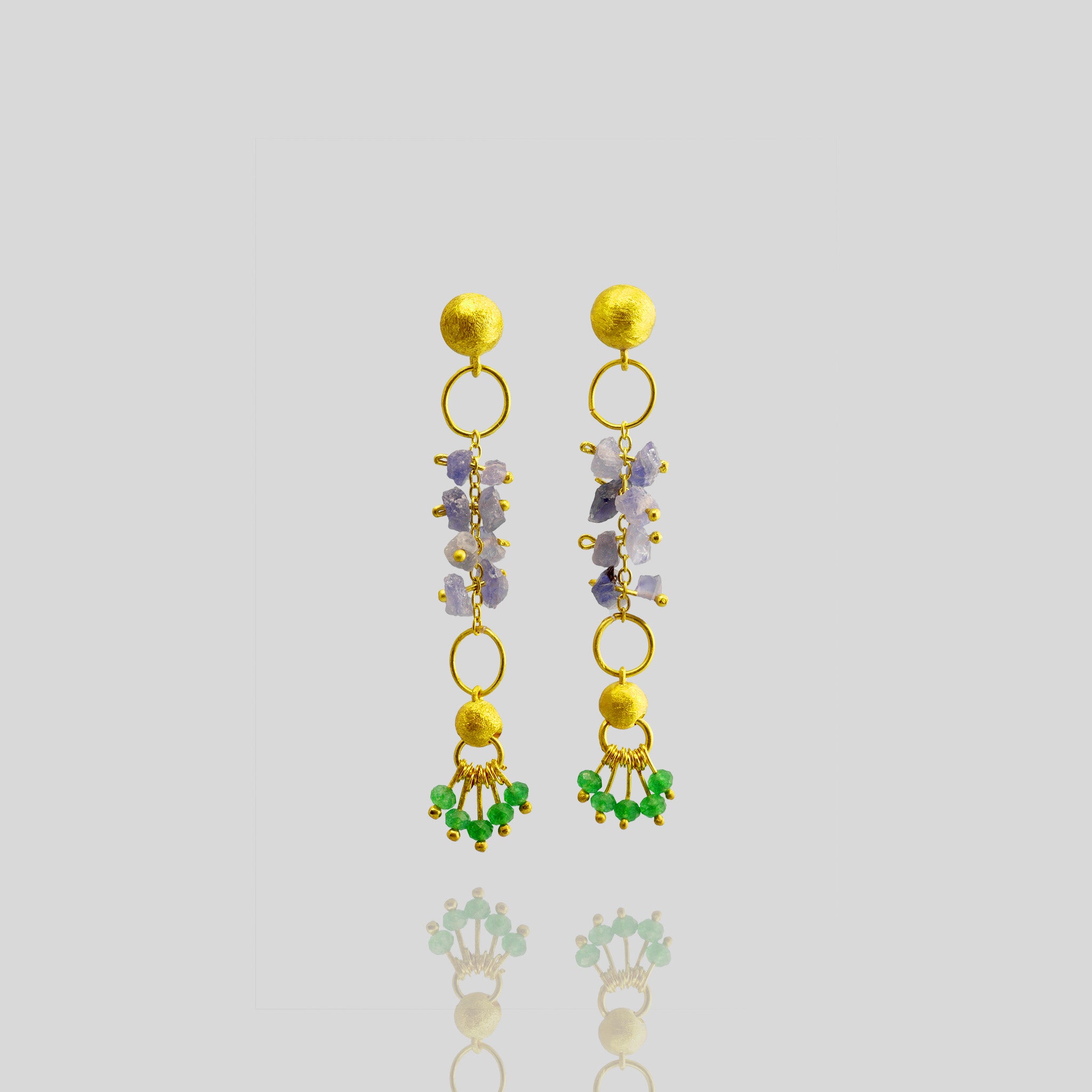 Hand-crafted 18k Yellow Gold Venus Earrings with raw Sapphire and Emerald accents, exuding organic beauty and luxury for any occasion.