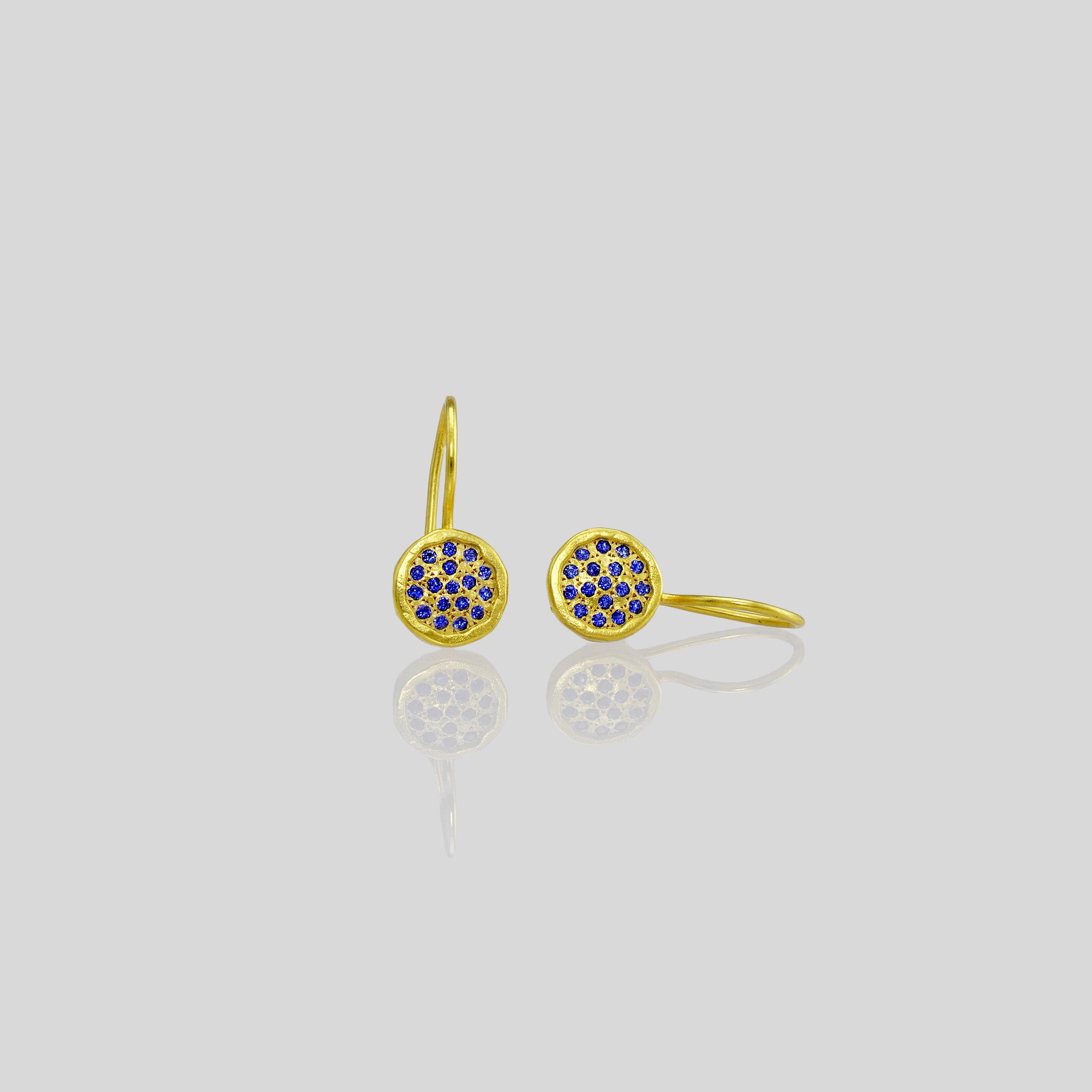 Gold drop earrings adorned with twinkling Sapphires, reminiscent of a starry night sky.