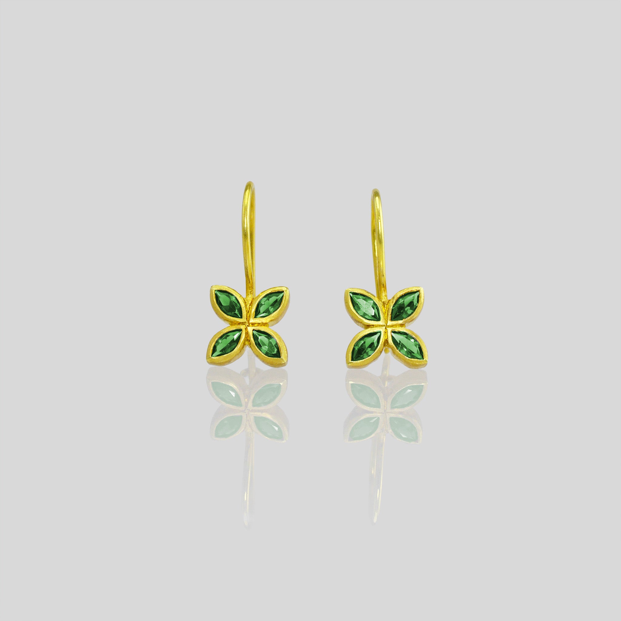 Close up of Dazzling Emerald flower earrings, crafted from 4 marquise gemstones. Lightweight, colorful and vibrant.