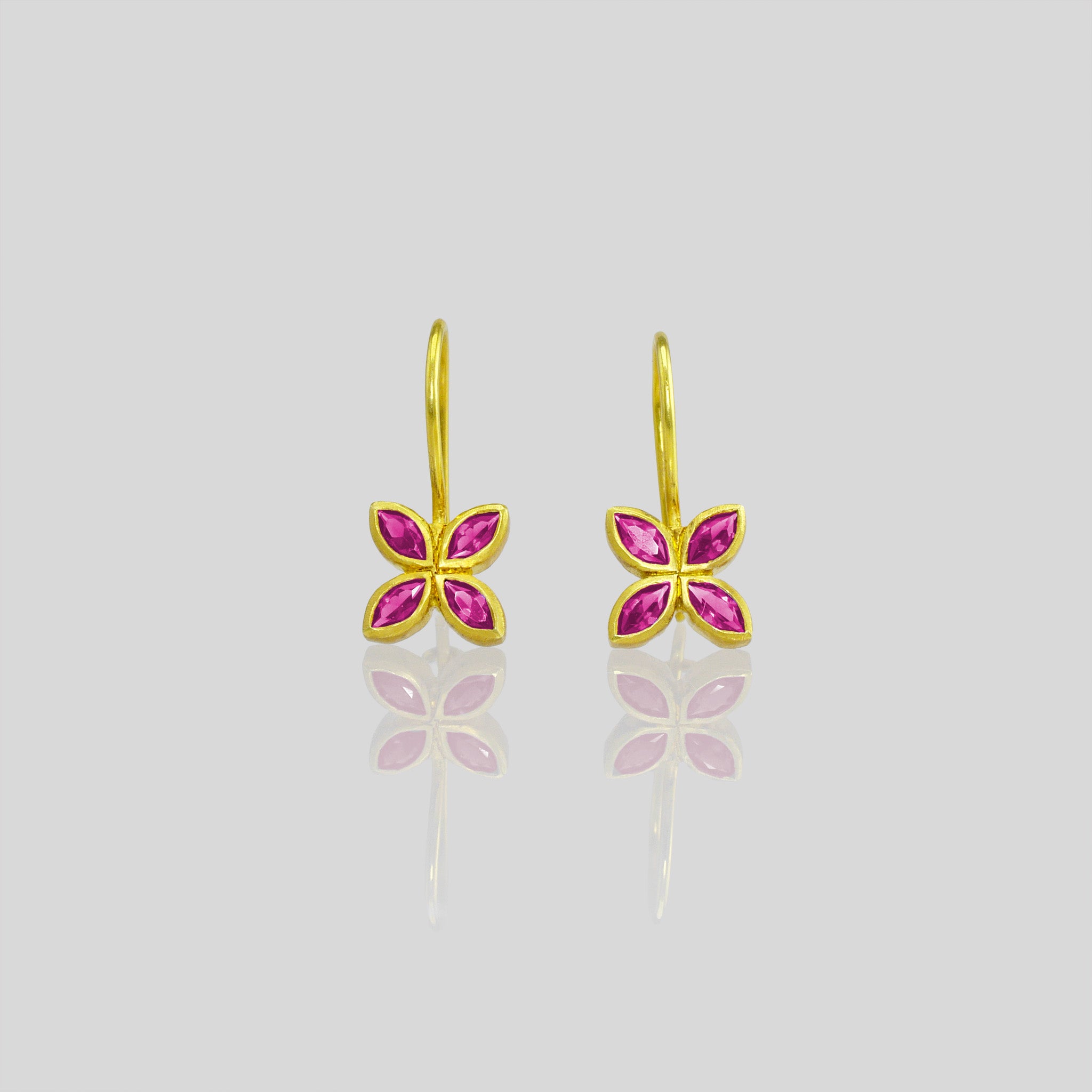 close up of Dazzling Ruby flower earrings, crafted from 4 marquise gemstones. Lightweight, colorful and vibrant.