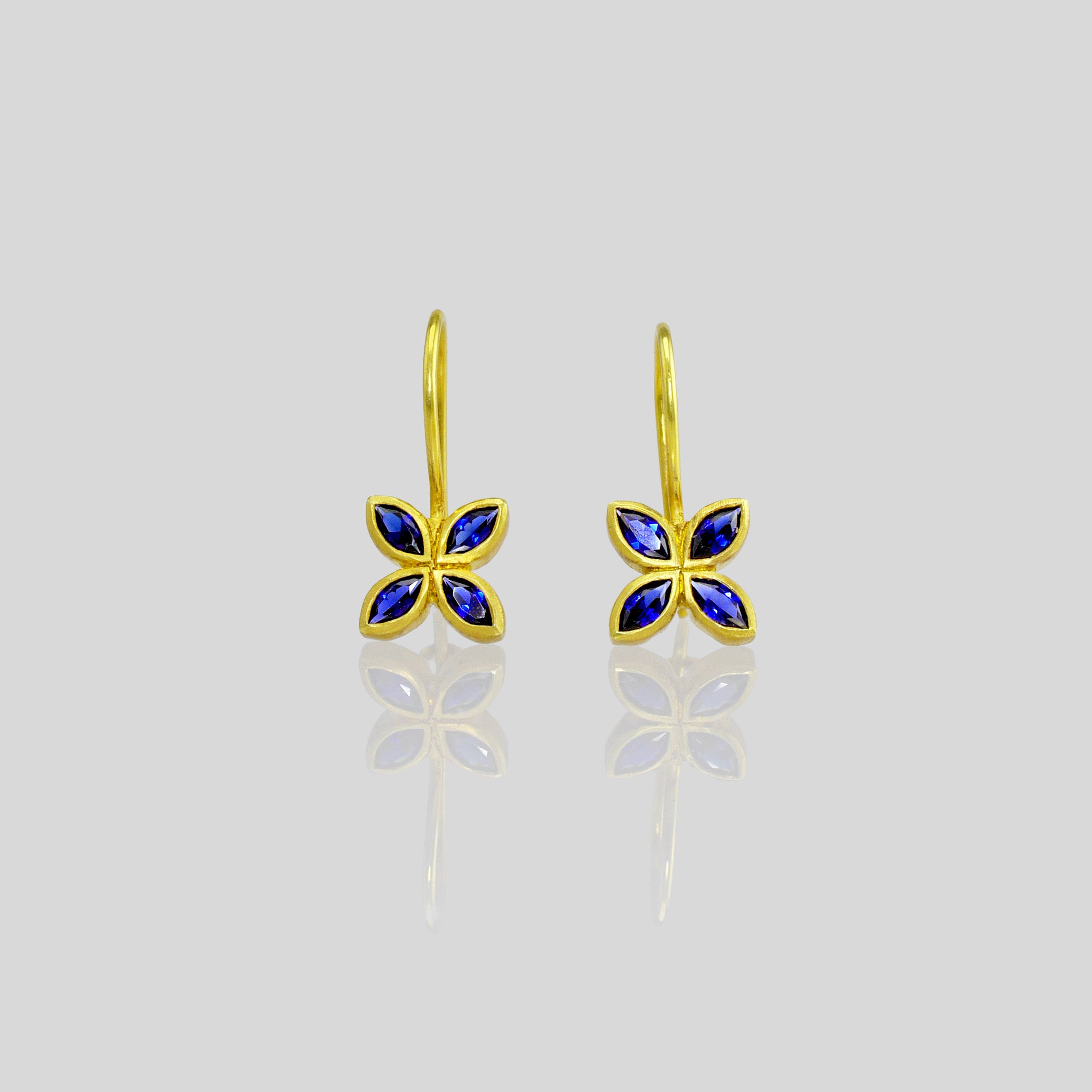 Close up of Dazzling Sapphire flower earrings, crafted from 4 marquise gemstones. Lightweight, colorful and vibrant.