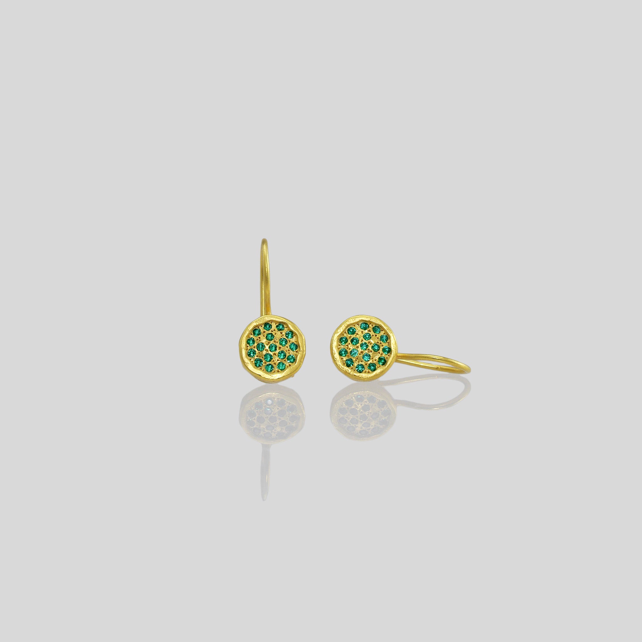 Gold drop earrings adorned with twinkling Emerald gemstones, reminiscent of a starry night sky.