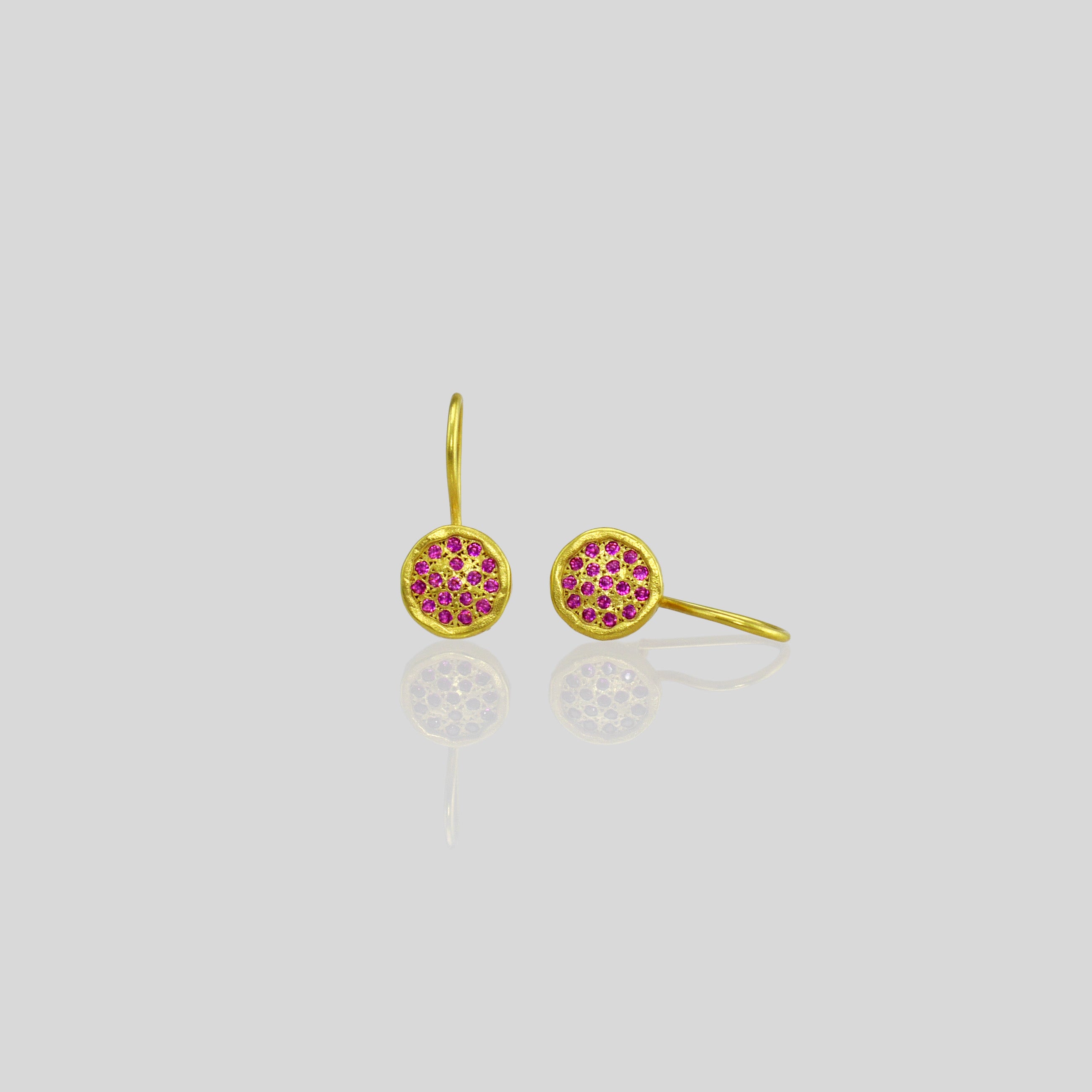 Gold drop earrings adorned with twinkling ruby gemstones, reminiscent of a starry night sky.