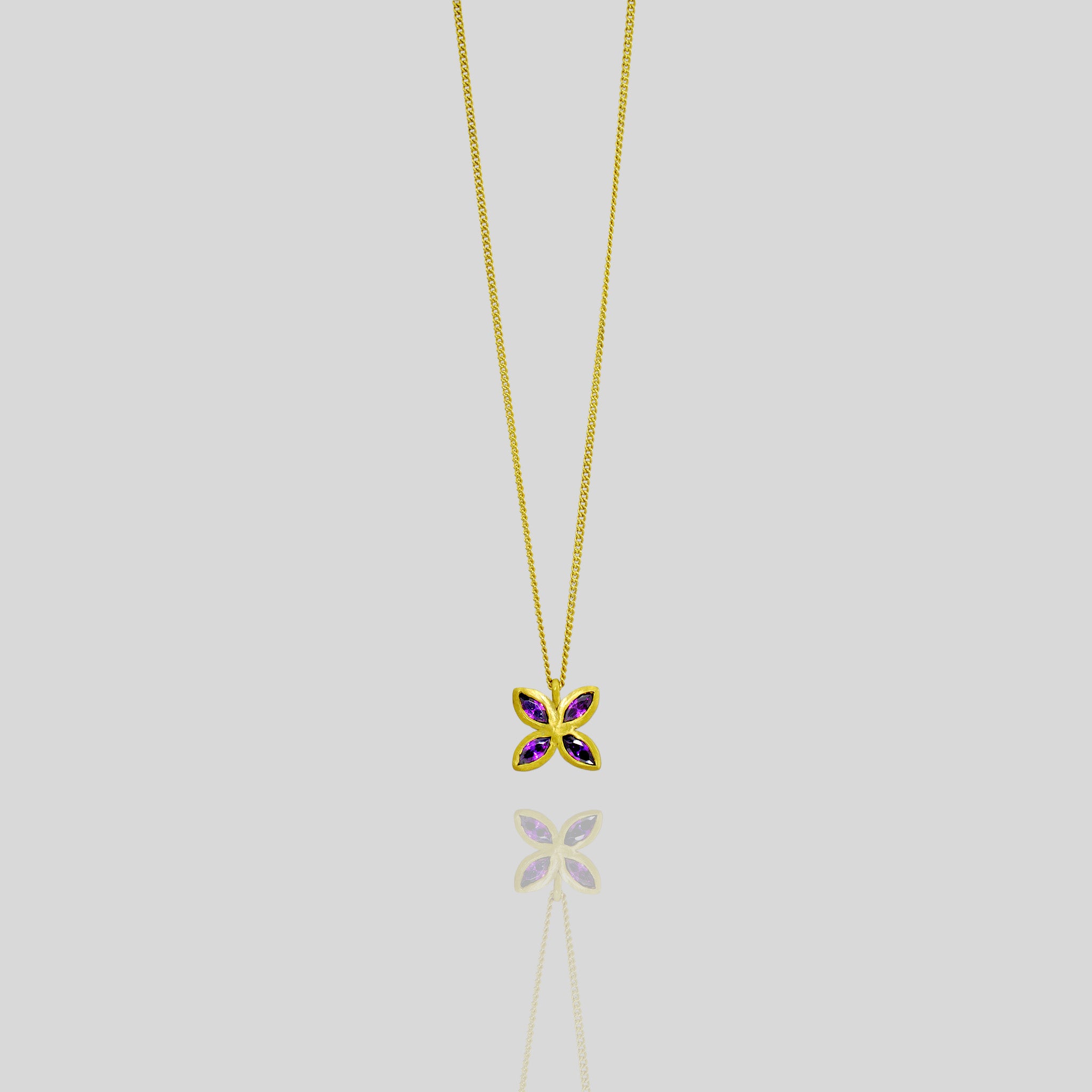 Elegant gold pendant with four marquise-cut amethysts arranged into a delicate flower design, offering luxury and beauty suitable for any gift occasion.