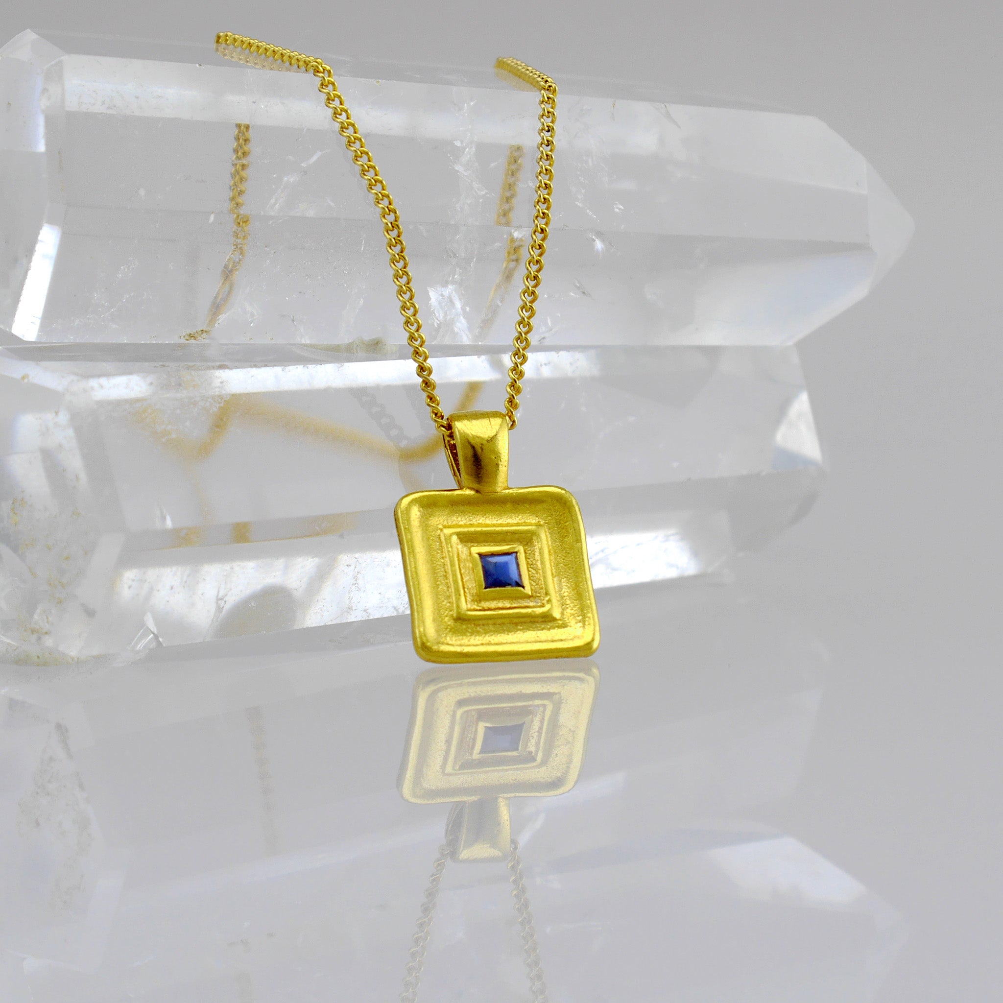 Detail of Pharaohs II - Handmade square gold pendant featuring a striking square Sapphire gemstone at its heart, crafted from Yellow Gold to mirror the majestic jewelry of ancient Egyptian Pharaohs.