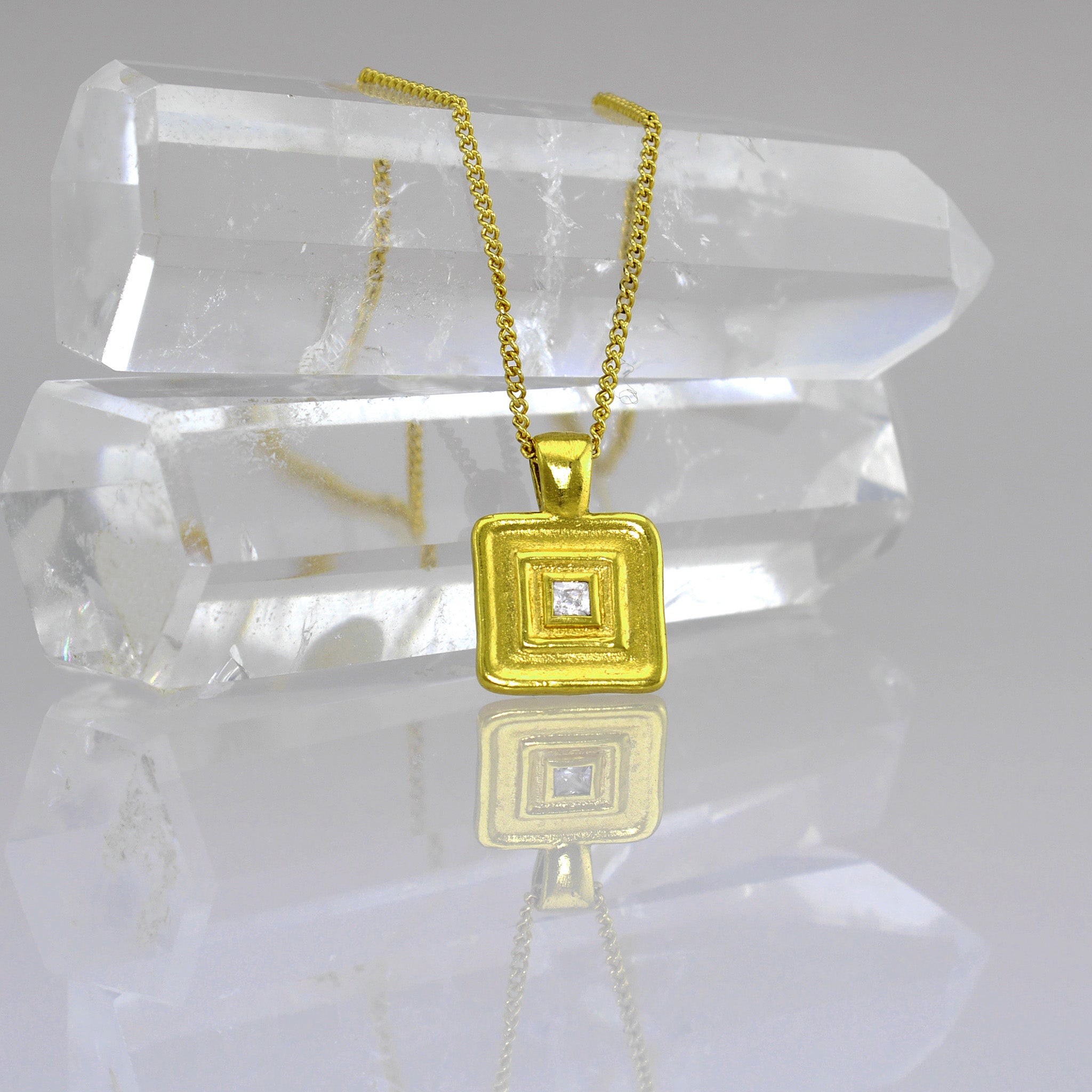 Detail of Handmade square gold pendant featuring a square diamond at its heart, crafted from Yellow Gold to mirror the majestic jewelry of ancient Egyptian Pharaohs.