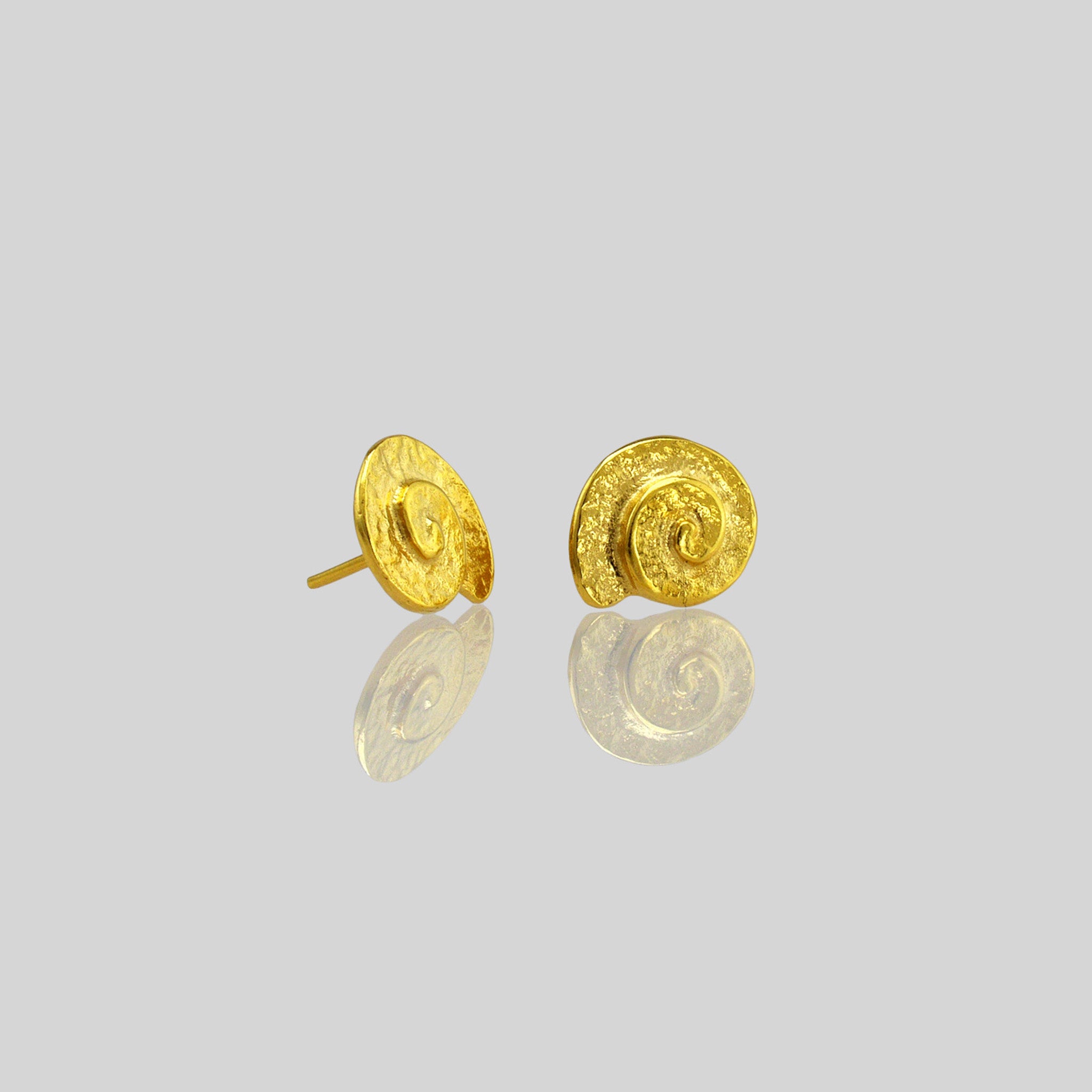 Close up of Classic and elegant yellow gold stud earrings with a textured arched spiral.