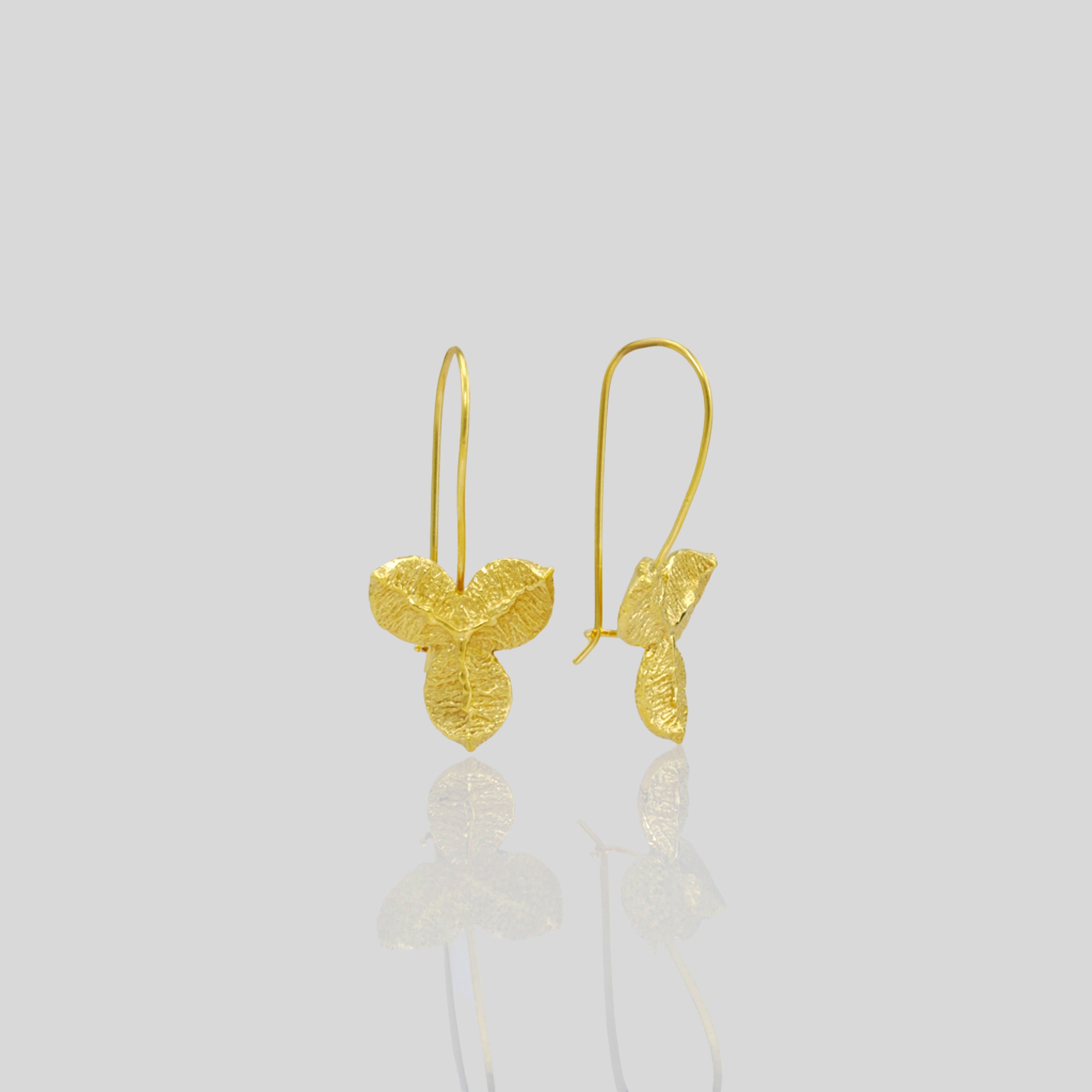 Nature-inspired Yellow Gold Drop Earrings with Unique Textured Design. Side angle.