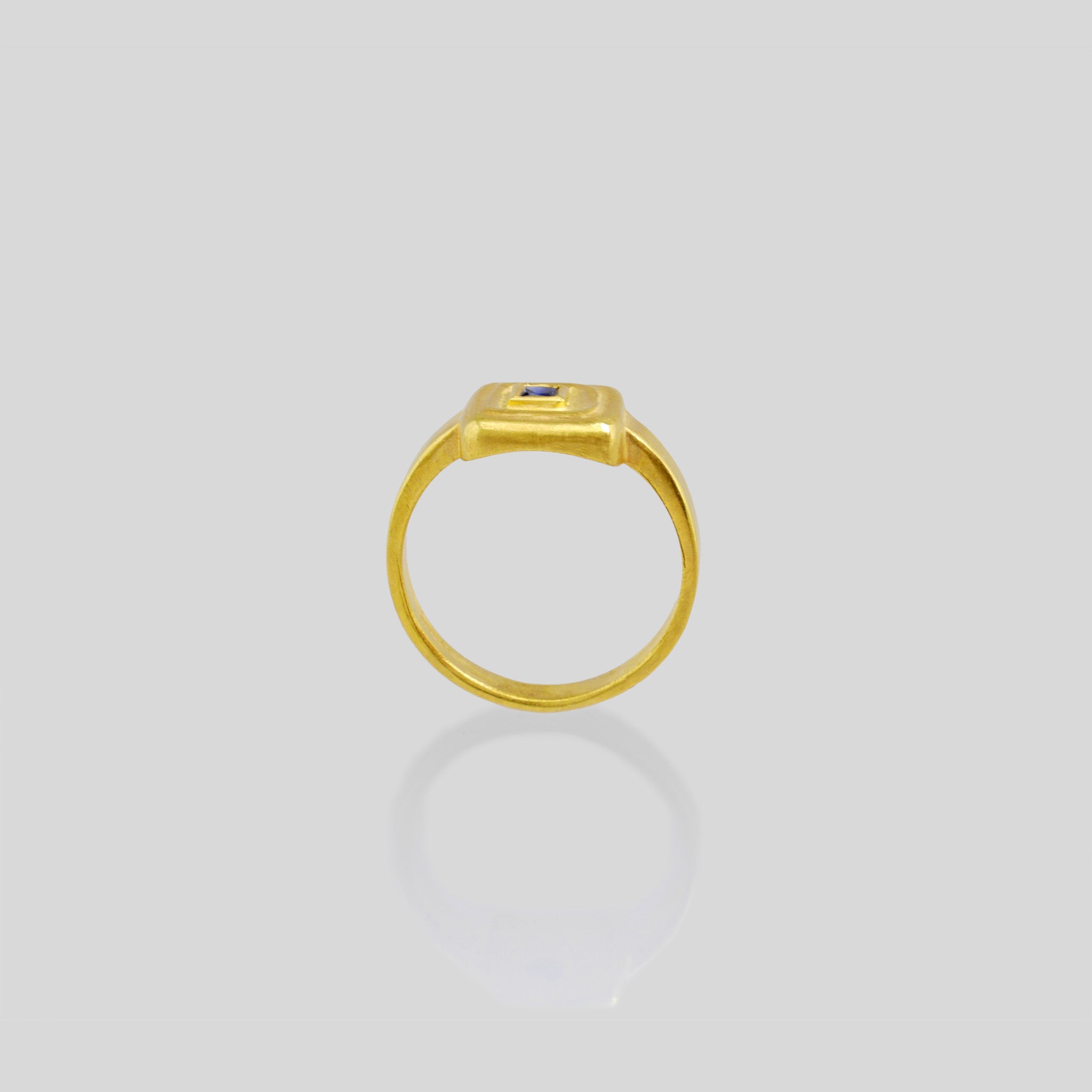 Side view of Handcrafted 18k Gold ring featuring a square Ruby set atop a square surface, evoking the ancient Egyptian era's golden jewelry of the Pharaohs.