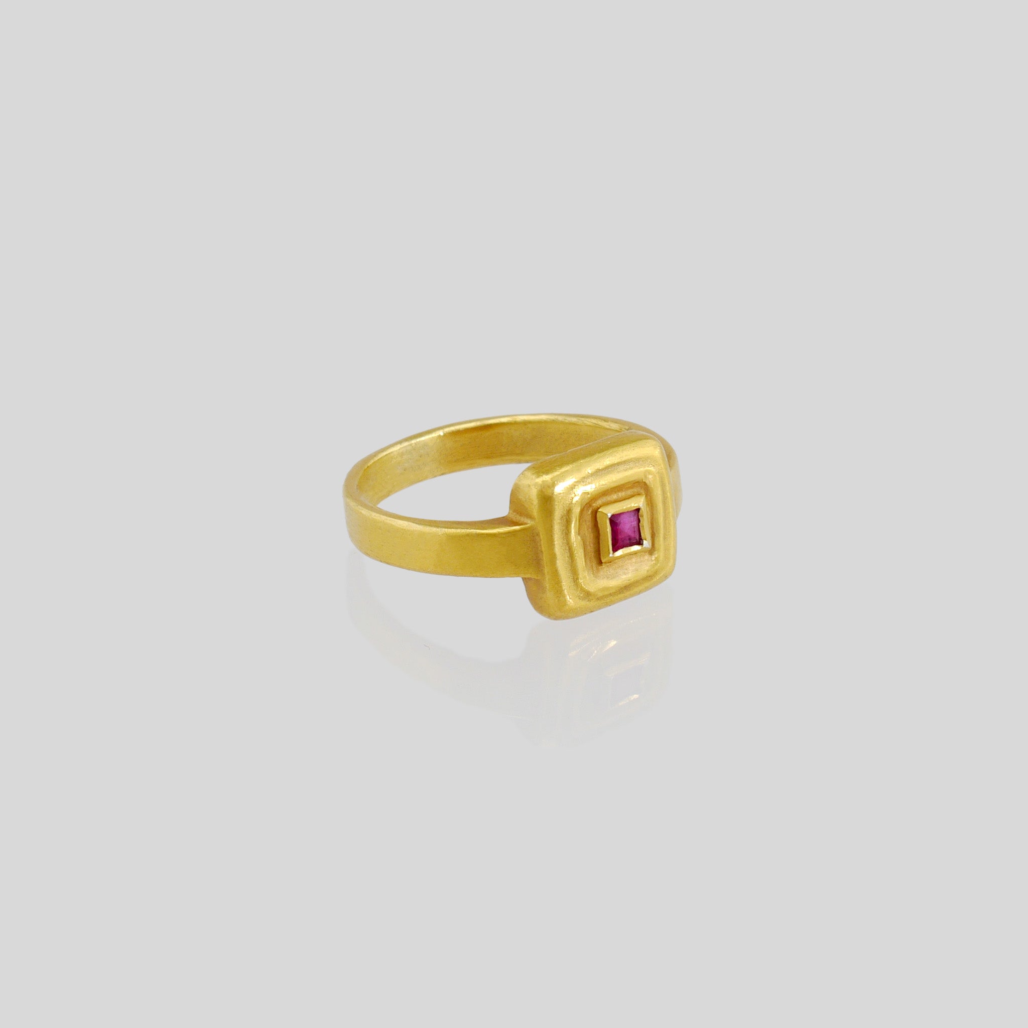 Handcrafted 18k Gold ring featuring a square Ruby set atop a square surface, evoking the ancient Egyptian era's golden jewelry of the Pharaohs.