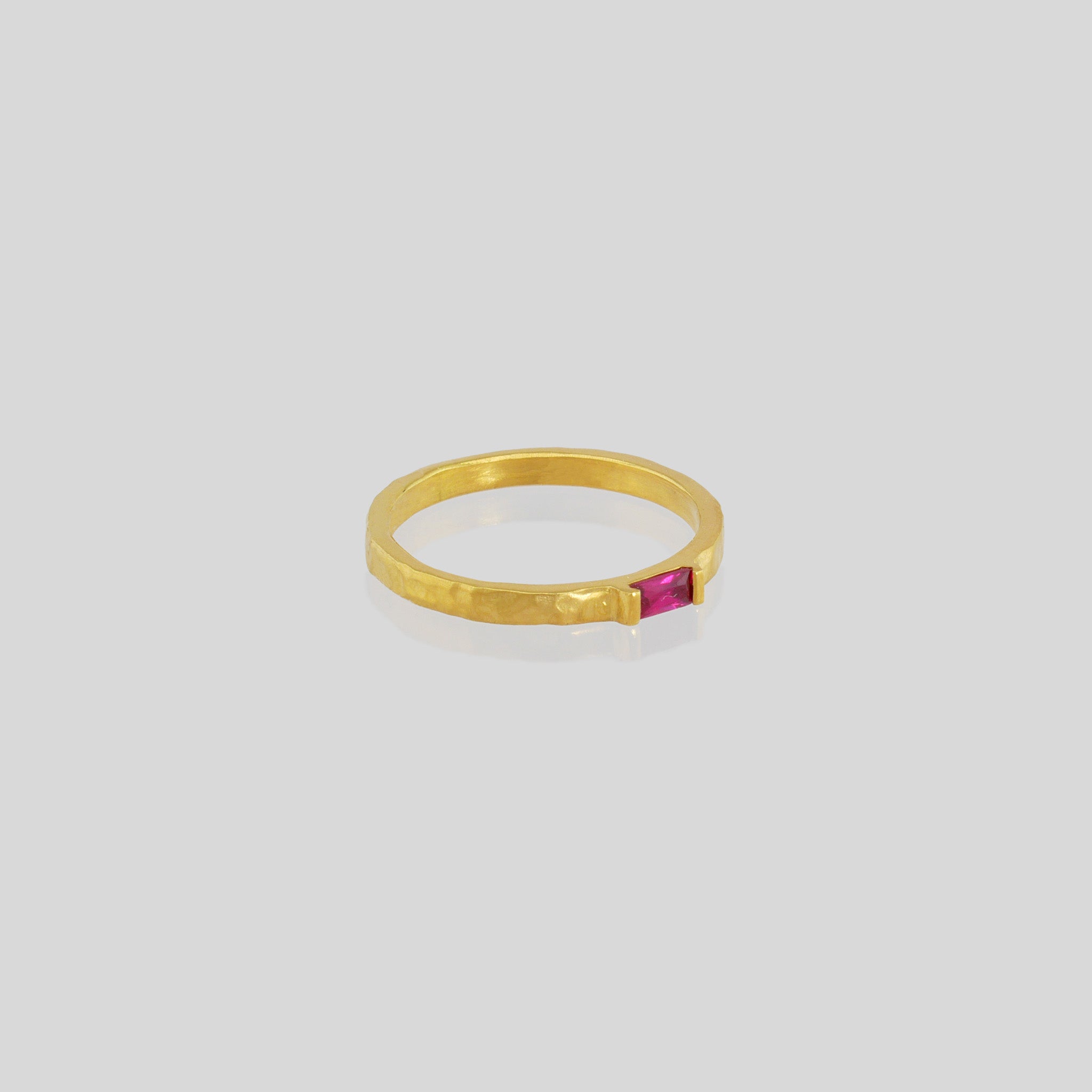 Handmade gold ring with hand-hammered surface and baguette Ruby accent. Timeless elegance in Yellow gold, a perfect addition to any ensemble.