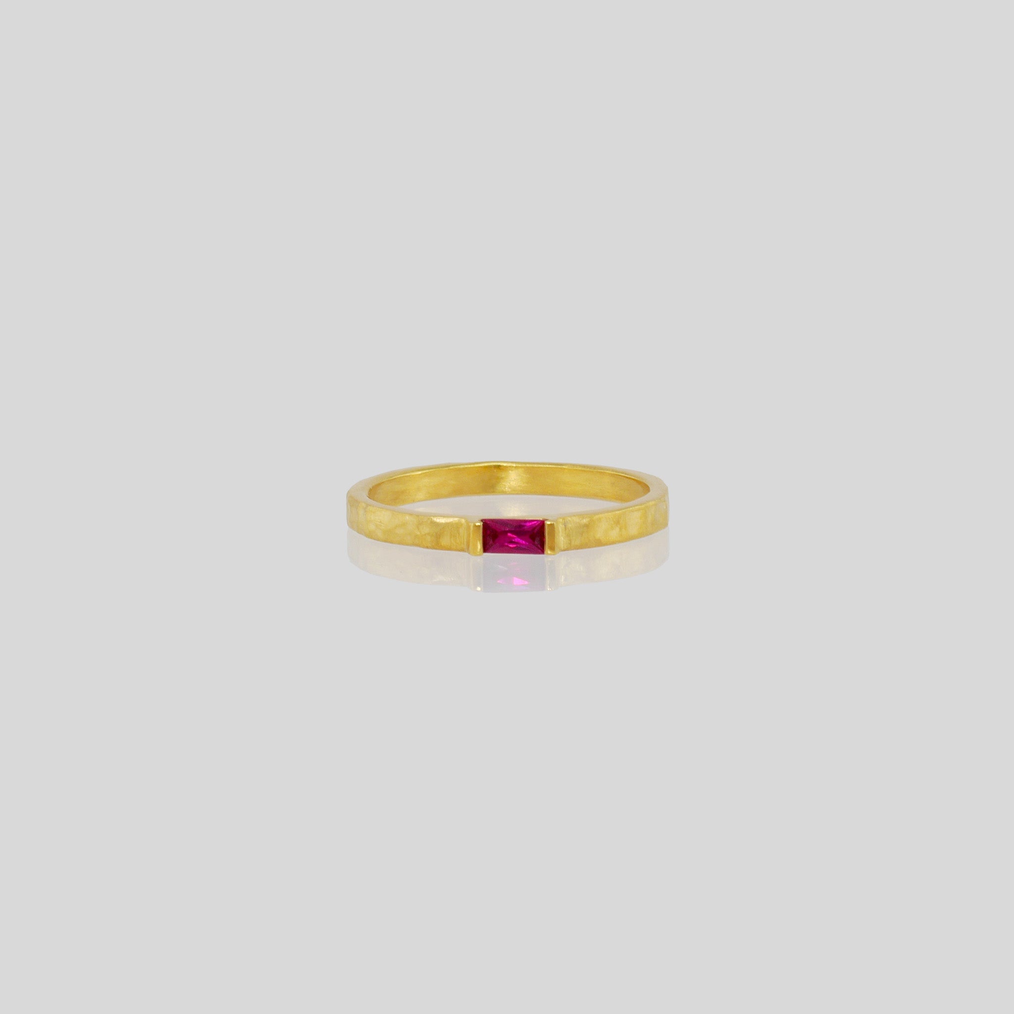 Handmade gold ring with hand-hammered surface and baguette Ruby accent. Timeless elegance in Yellow gold, a perfect addition to any ensemble.