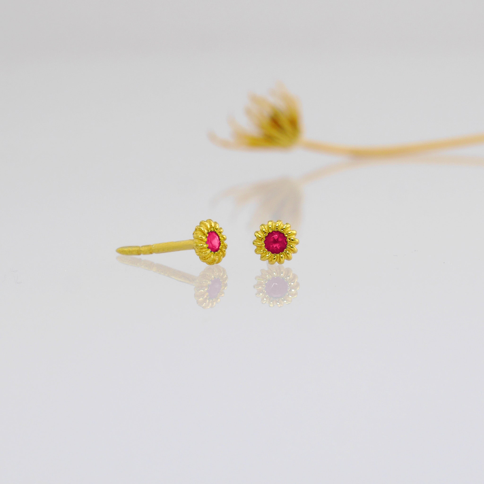 Tiny, coiled 18k gold studs with Ruby.
