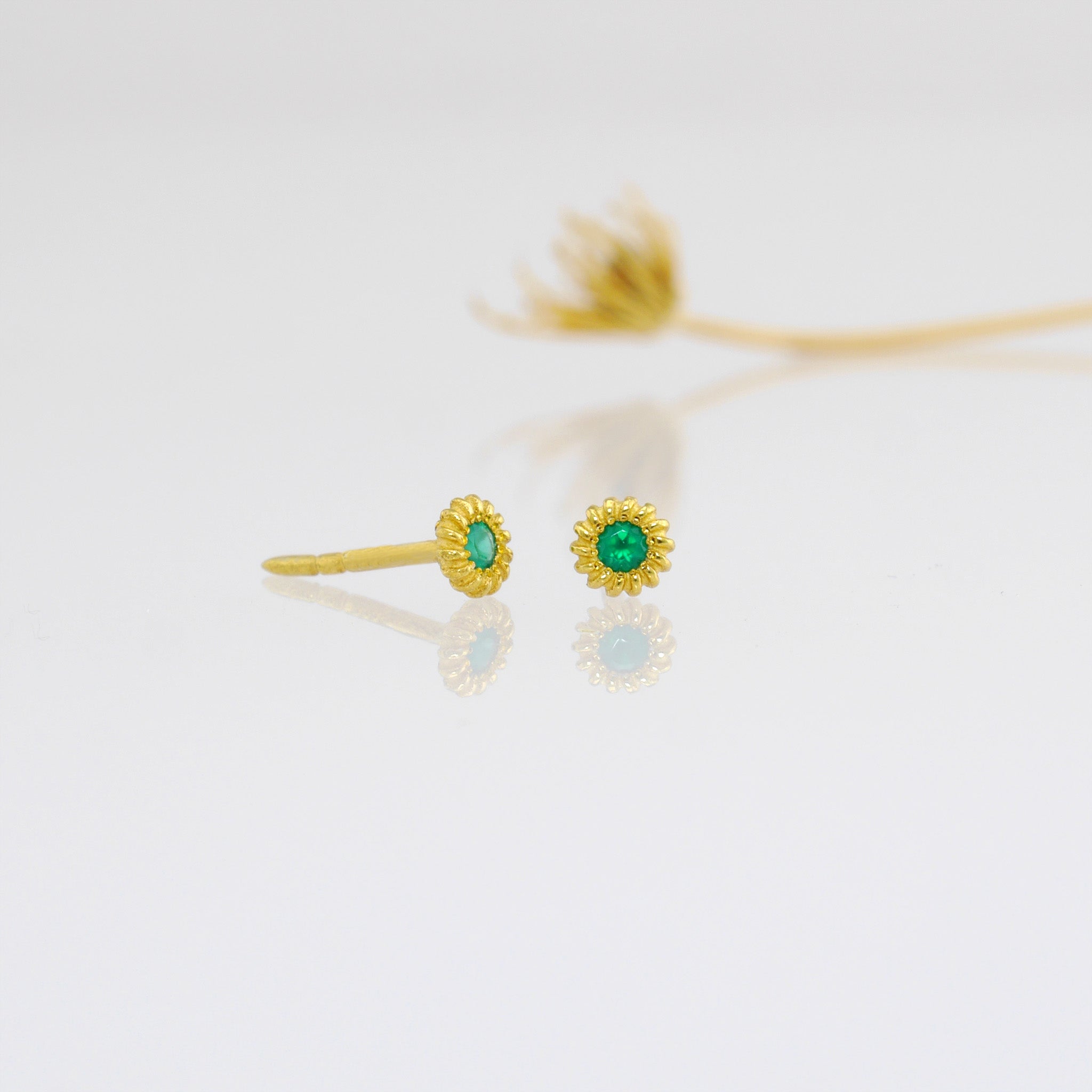 Tiny, coiled 18k gold studs with Emerald.