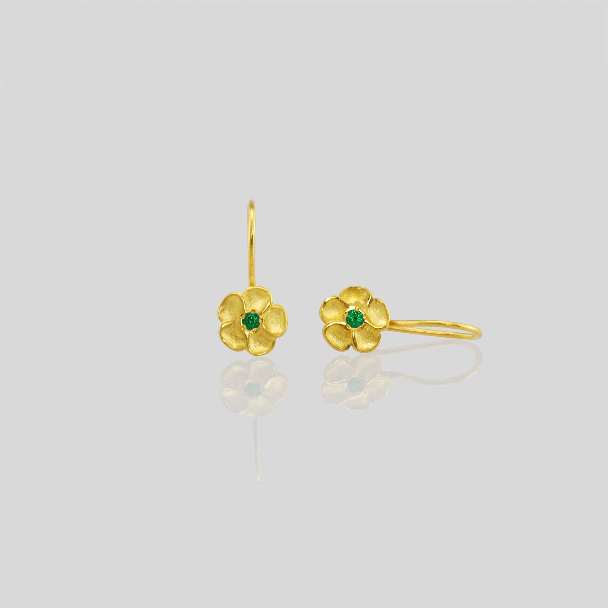Delicate yellow gold flower drop earrings with a sparkling Emerald center. Perfect for any occasion!