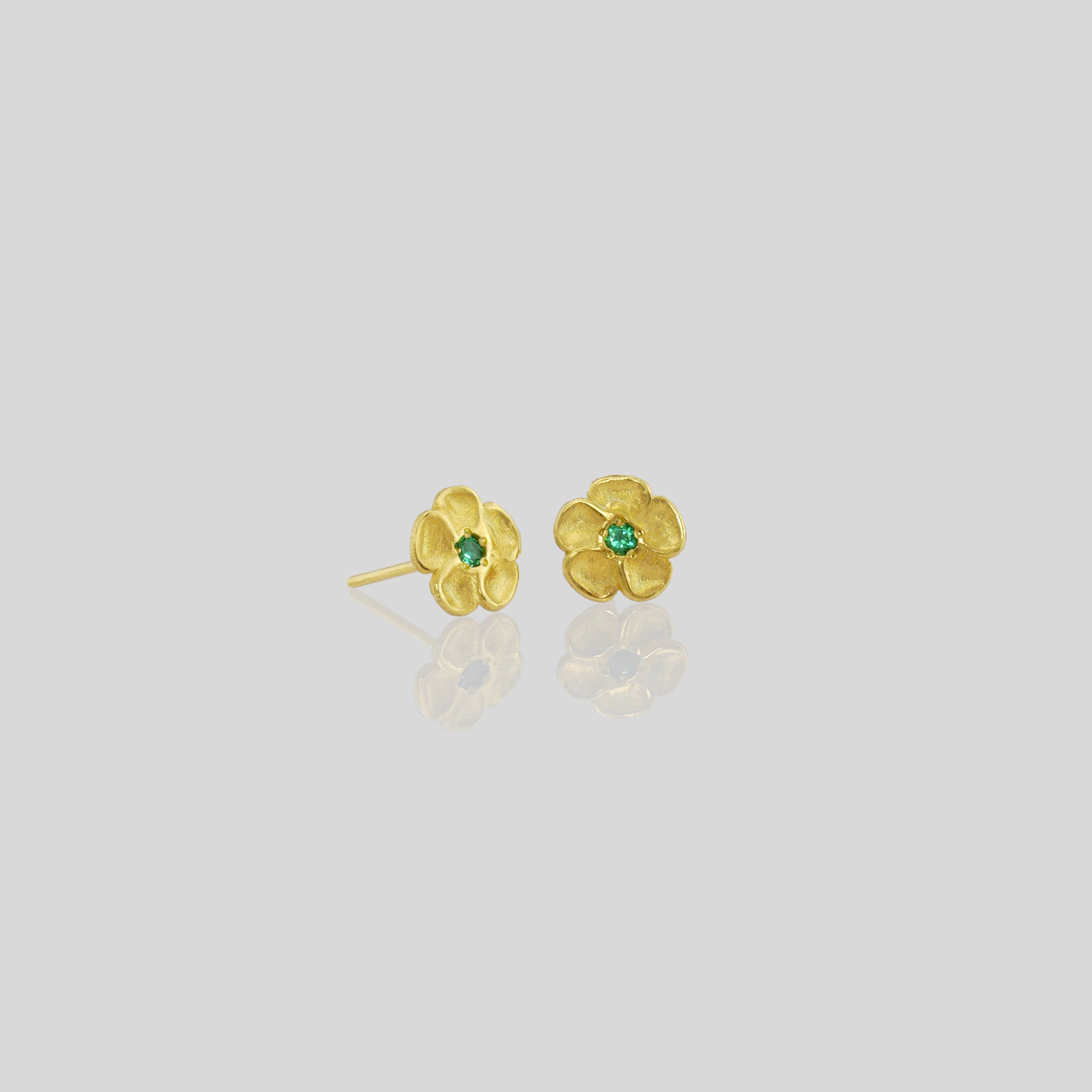 Delicate yellow gold flower stud earrings with a sparkling Emerald center. Perfect for any occasion!
