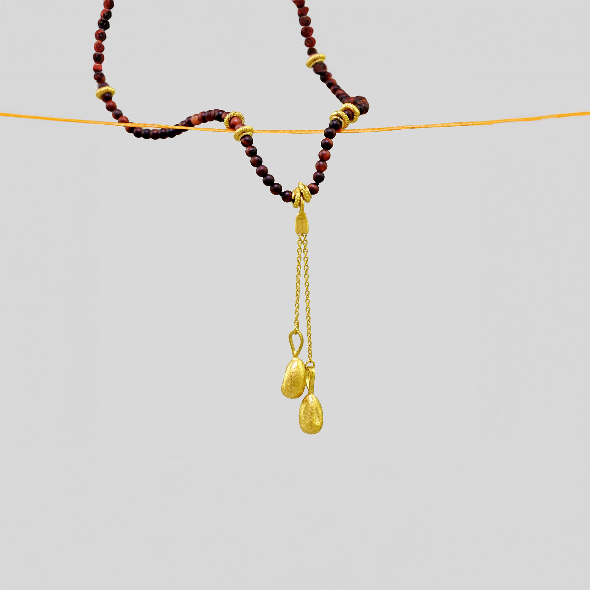 Dark Jasper Necklace with Gold Seeds pendant, featuring natural charm and elegance.