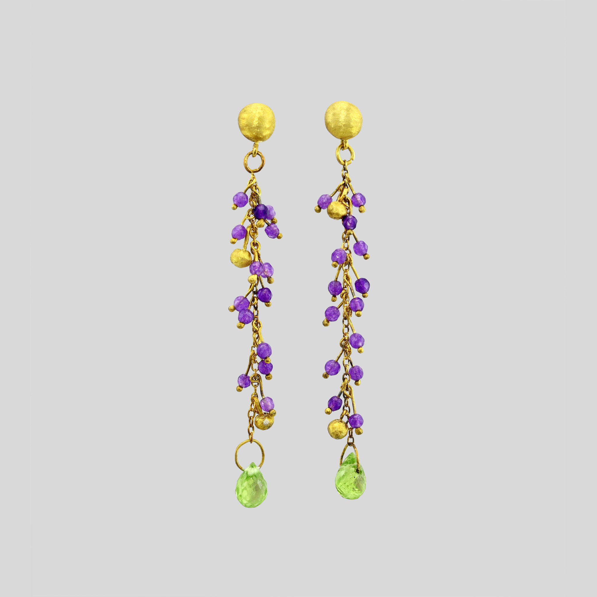 close up of Venus Gold Stud Earrings with Amethyst Beads & Drop-Shaped Peridot - Elegant Half Cap and Gold Threads Design.